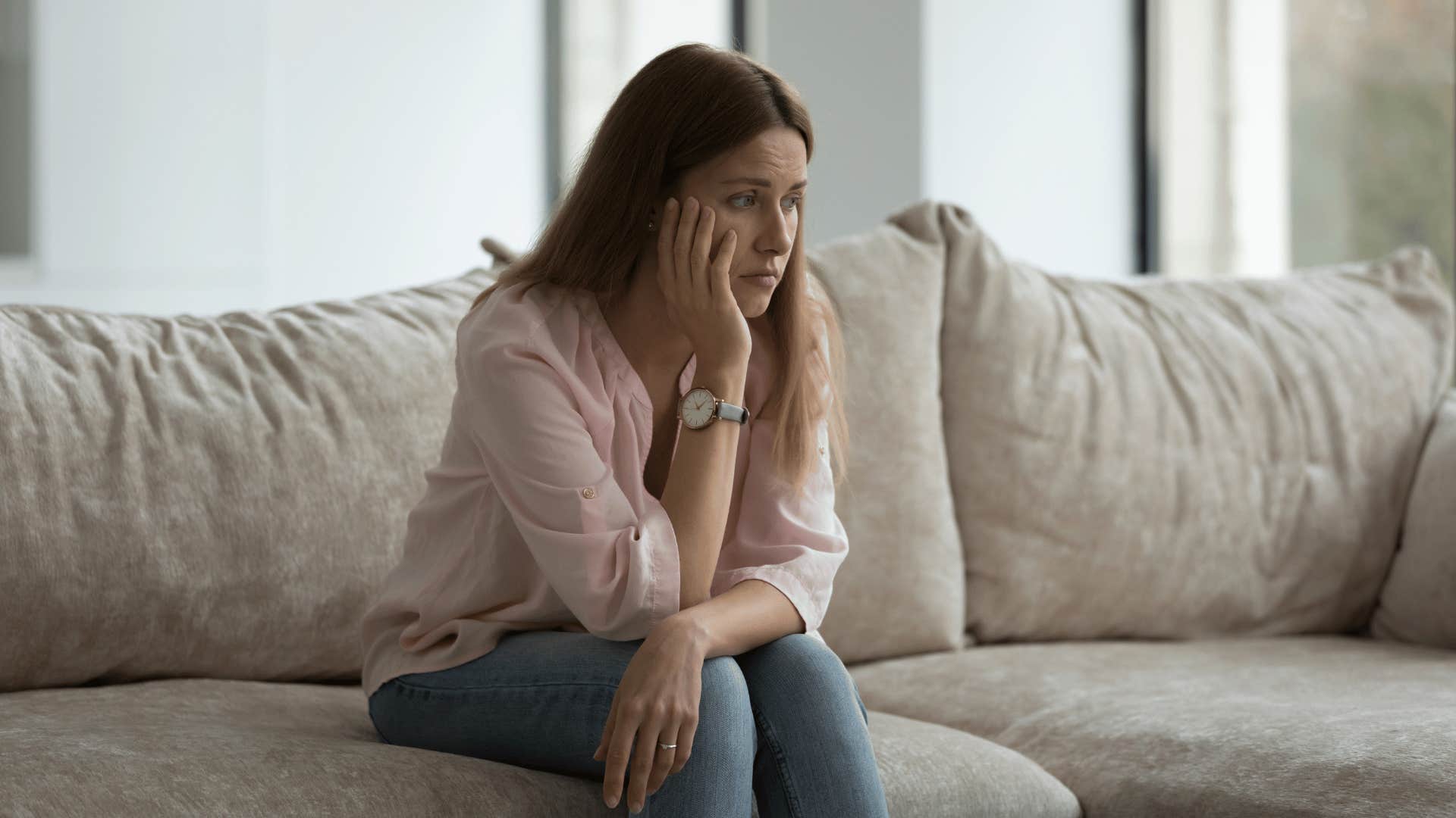 woman sitting alone on couch