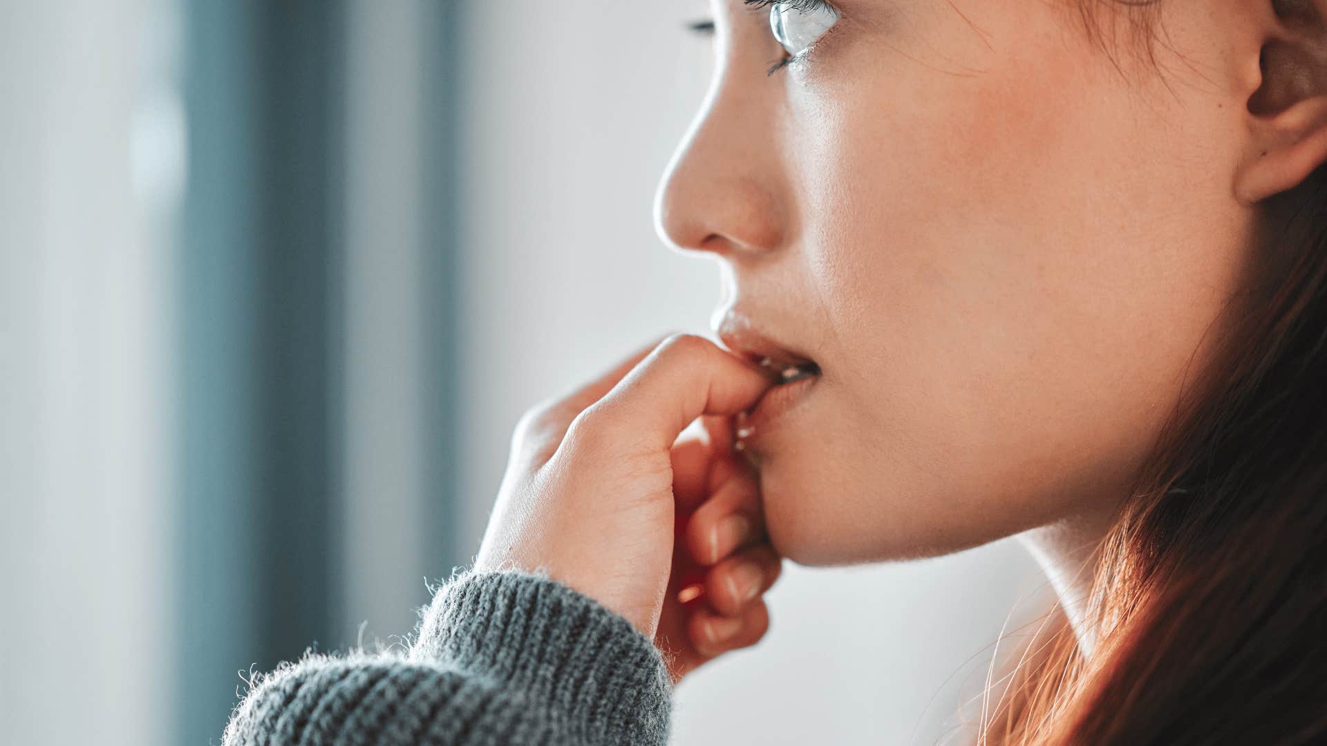 nervous woman biting nail