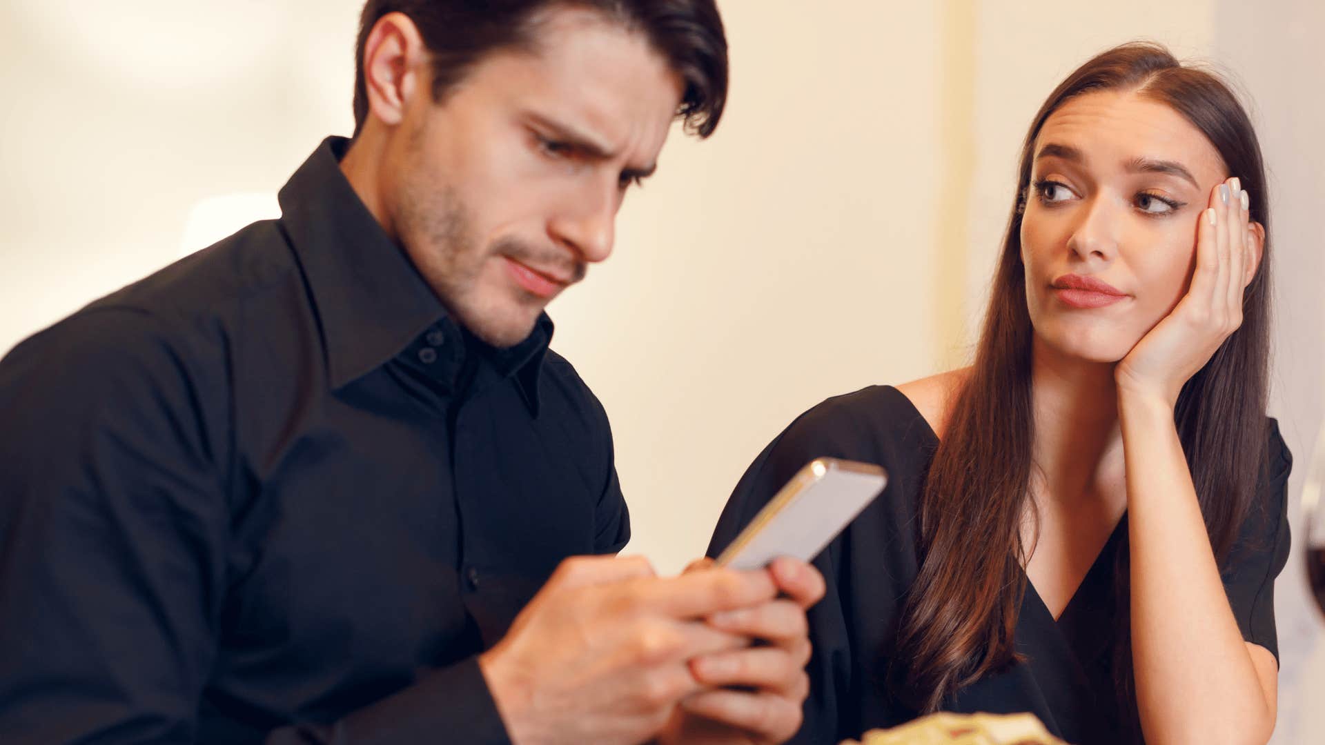 man on phone ignoring woman