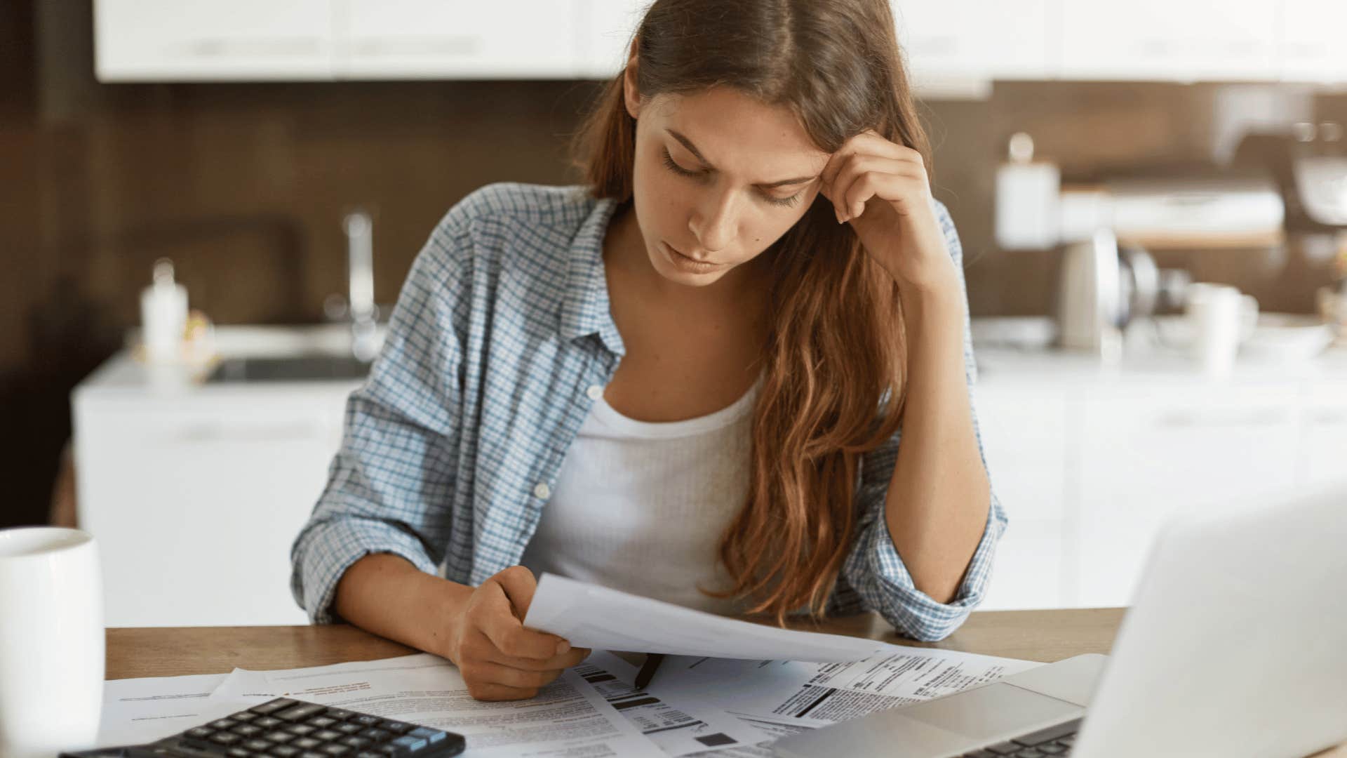 worried woman looking at bills