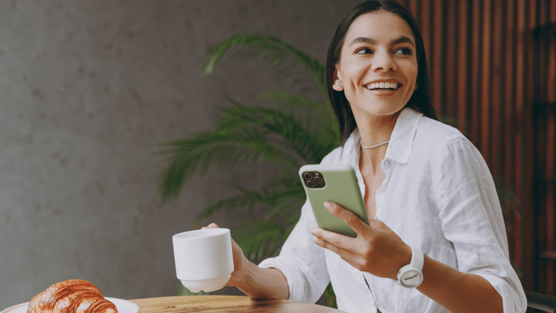 smiling woman alone at coffee shop