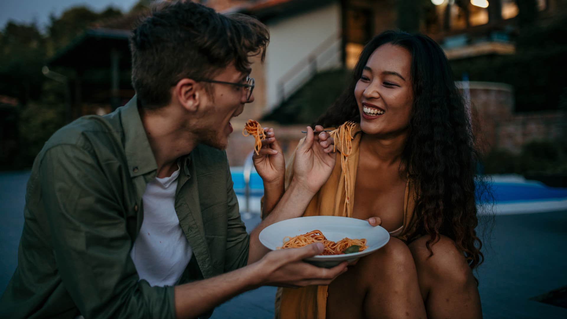 Loving diverse couple sitting outdoors expressing genuine gratitude