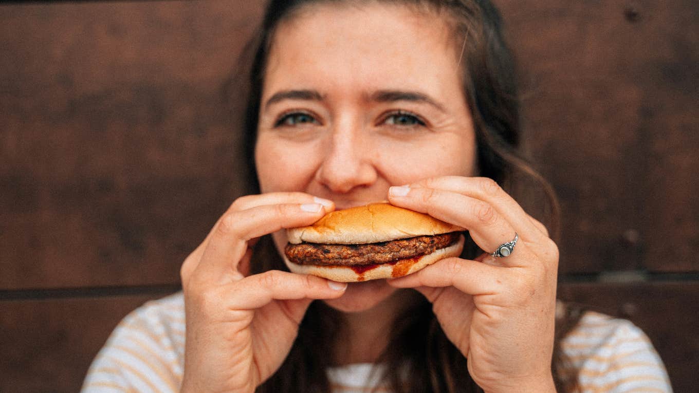 Woman eating fast food. 