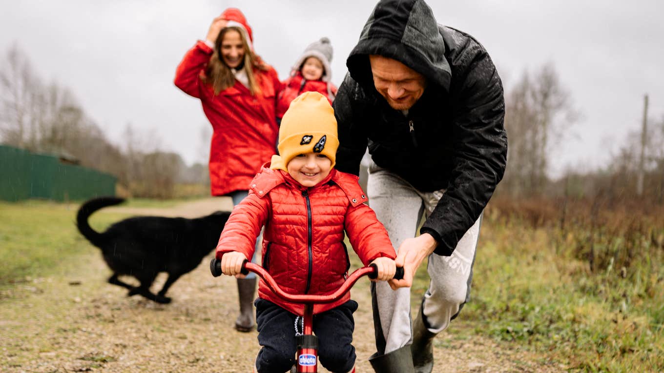 Helicopter parents following their child on his bike.