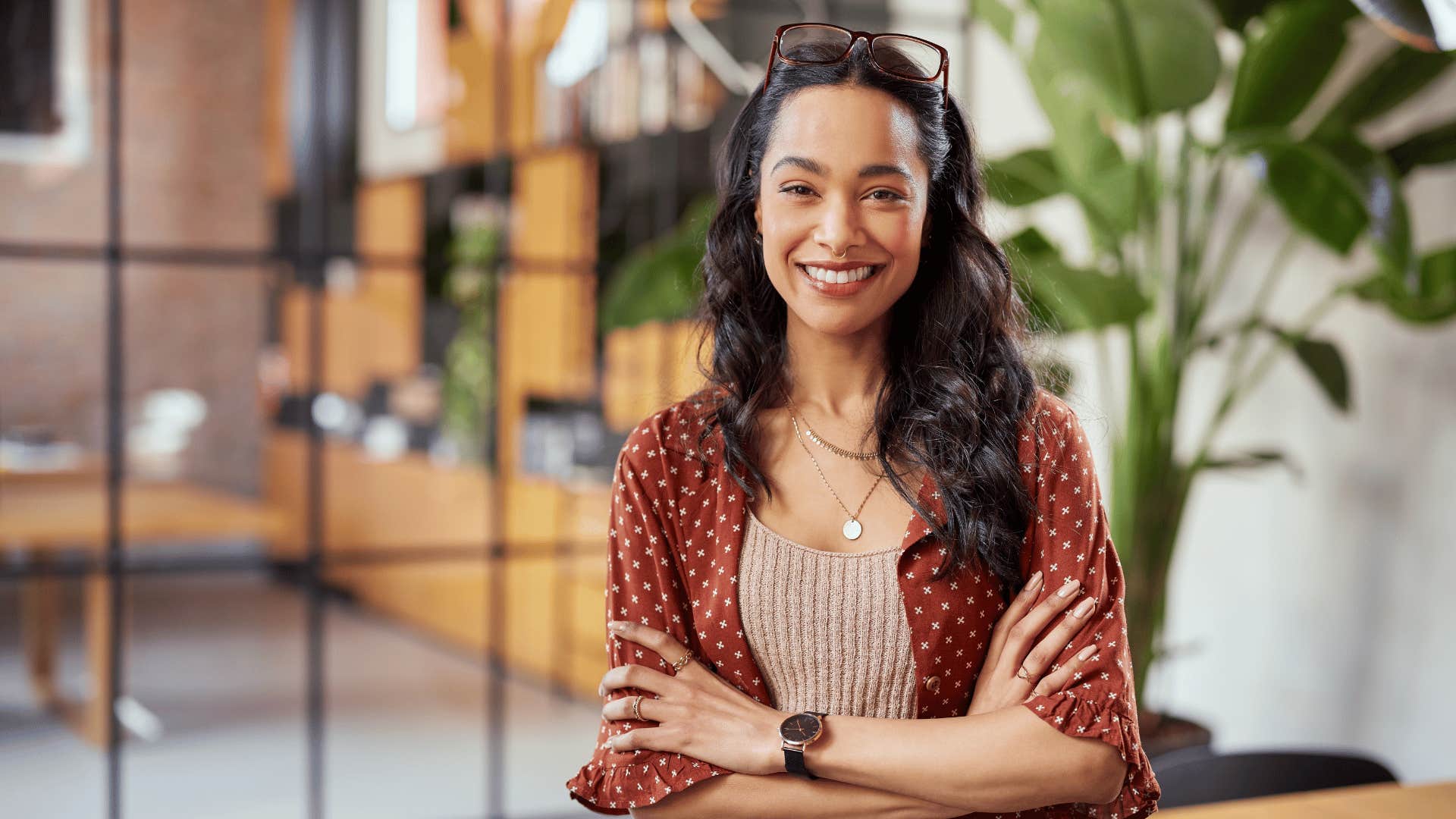 Smiling woman with crossed arms