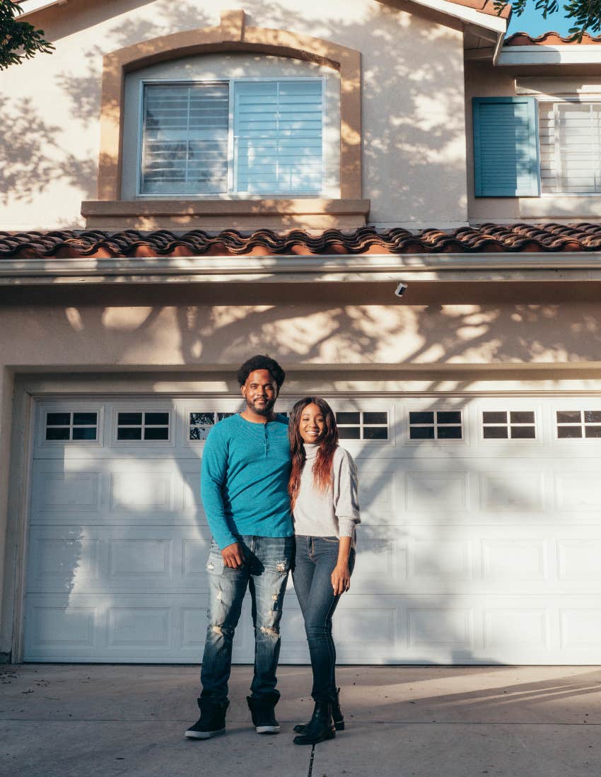 Couple outside a community standard colored driveway.