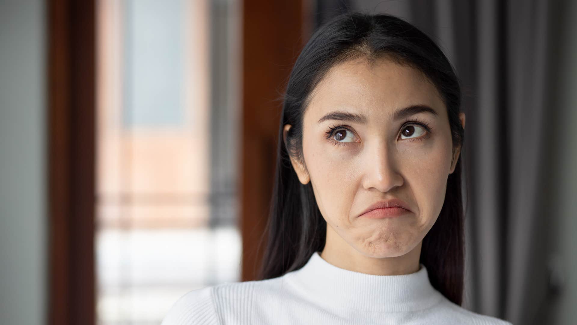 upset unhappy woman rolling her eye	