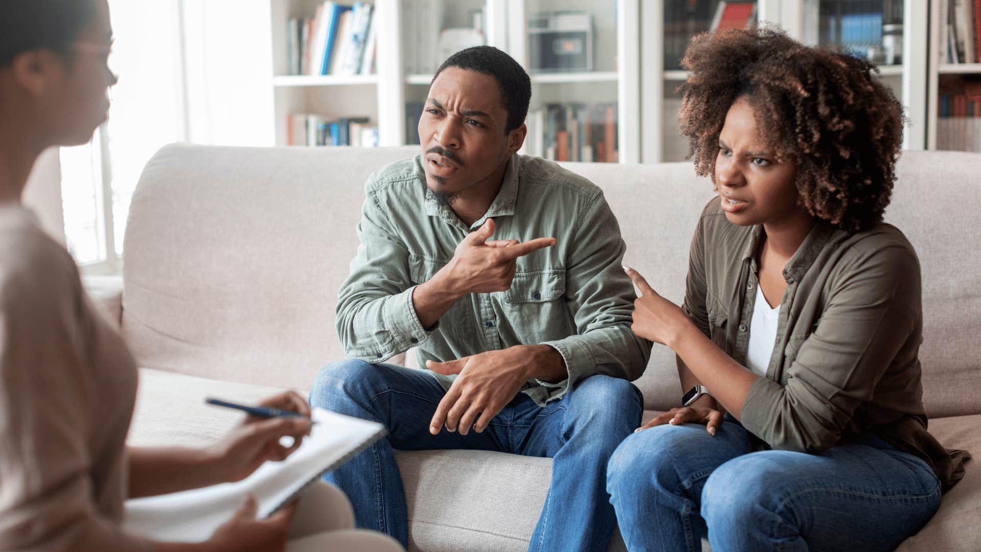 Couple at counselor try to discuss emotional topic