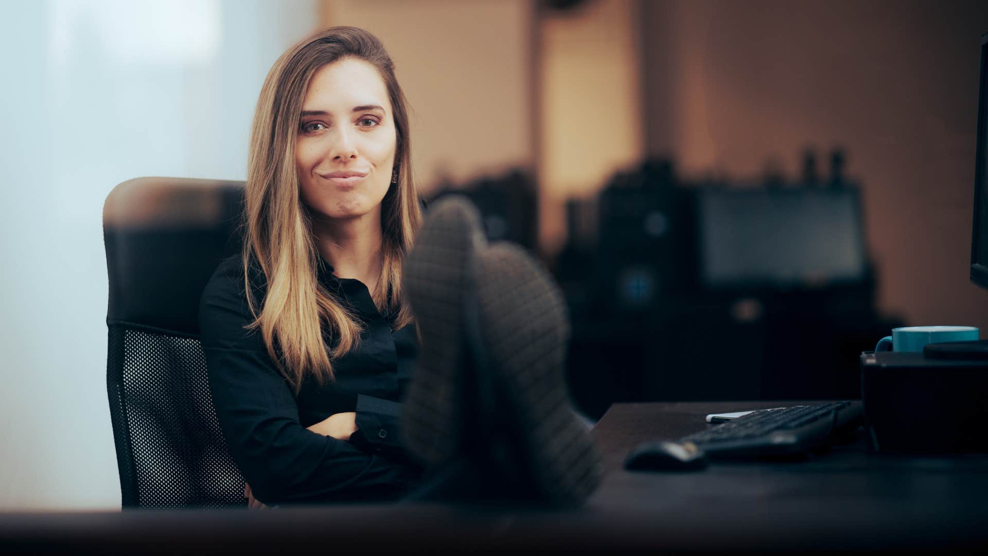 Smug woman with her Feet on the Desk