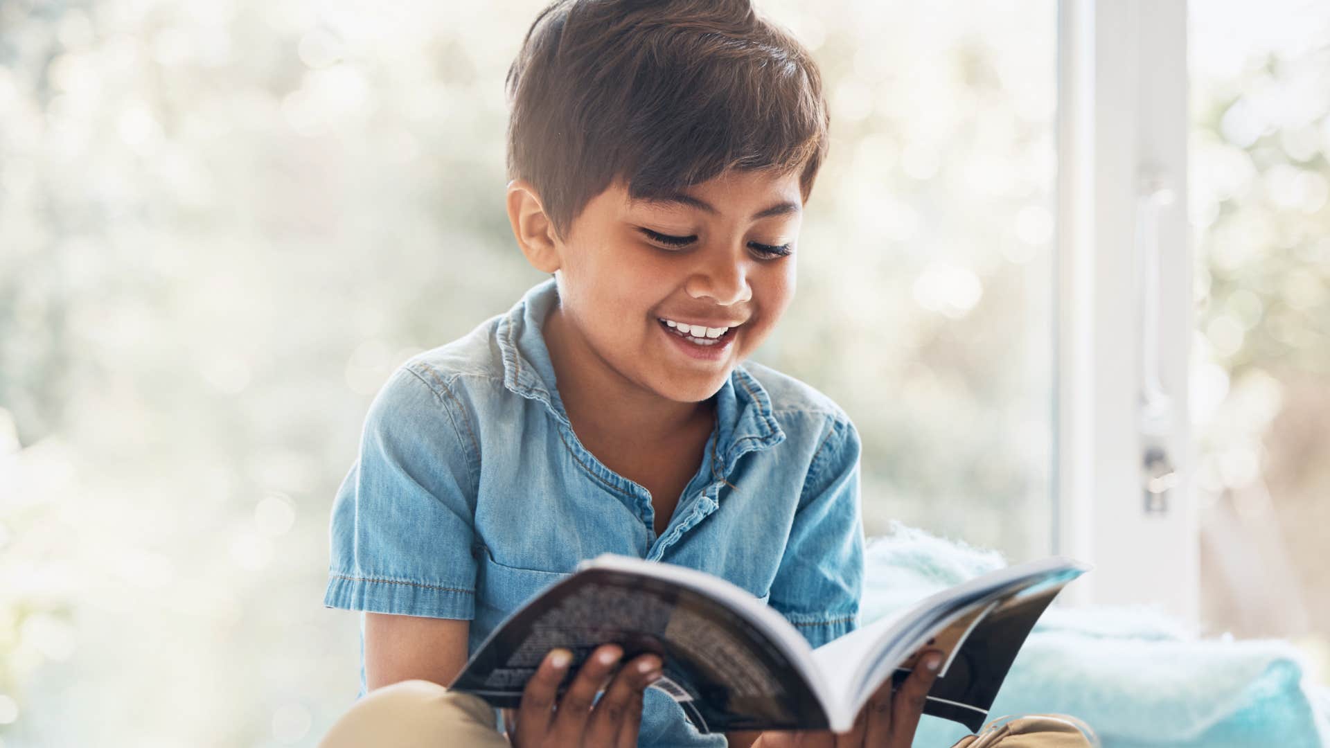 young boy reading alone