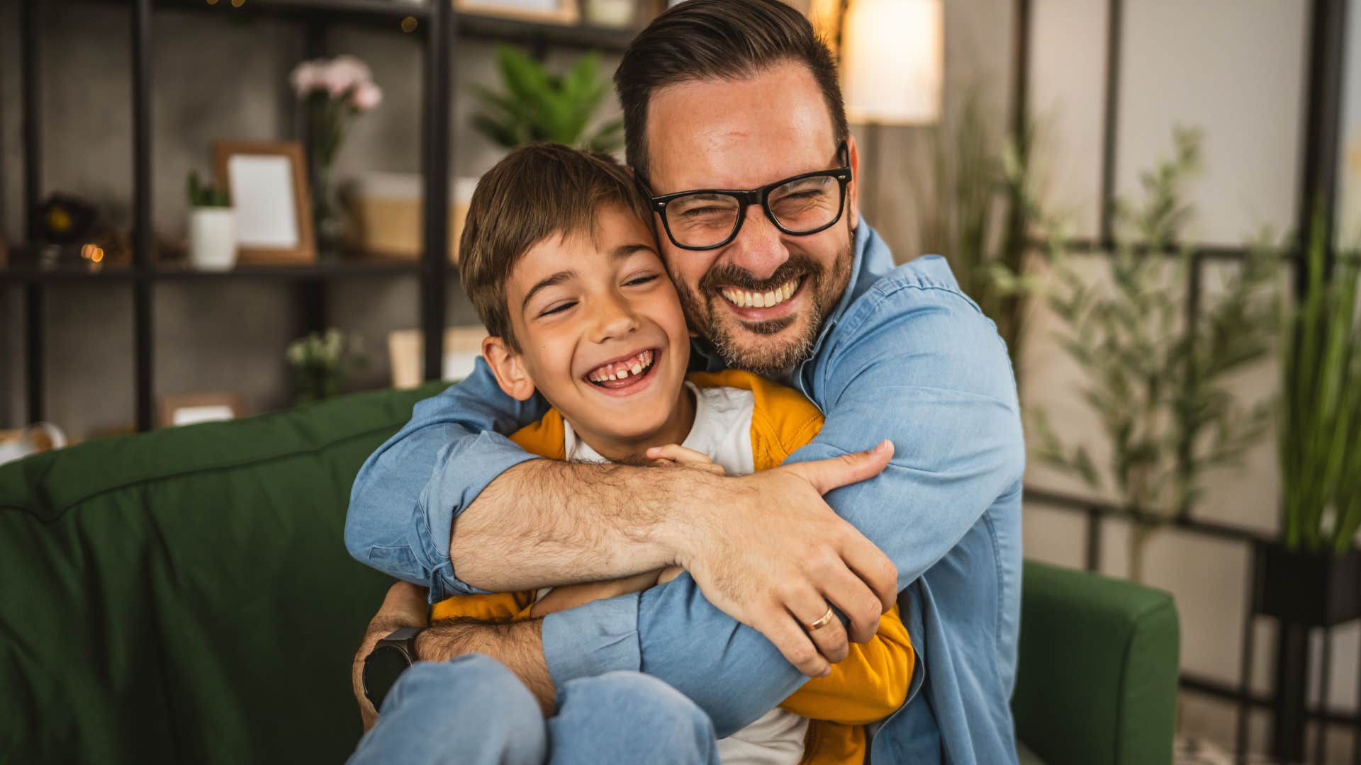 dad smiling and laughing with his young son