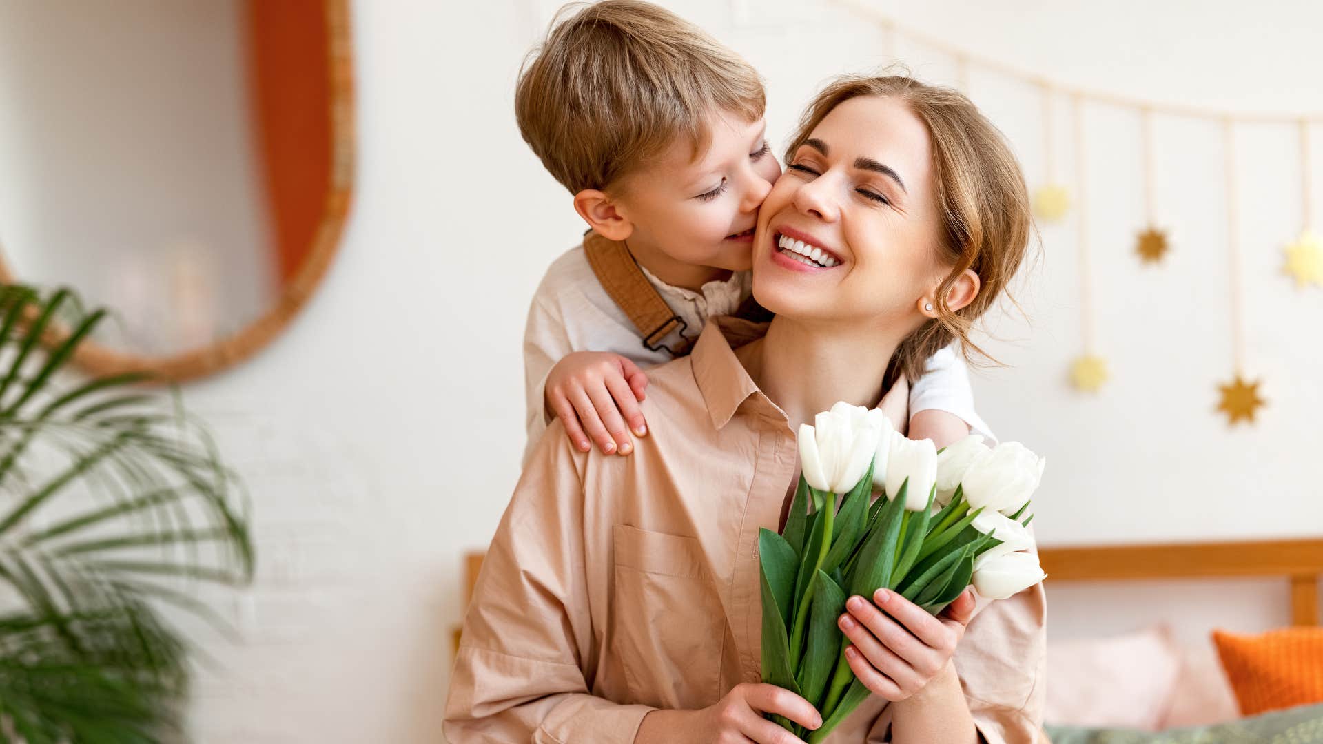 young boy kissing his mom's cheek