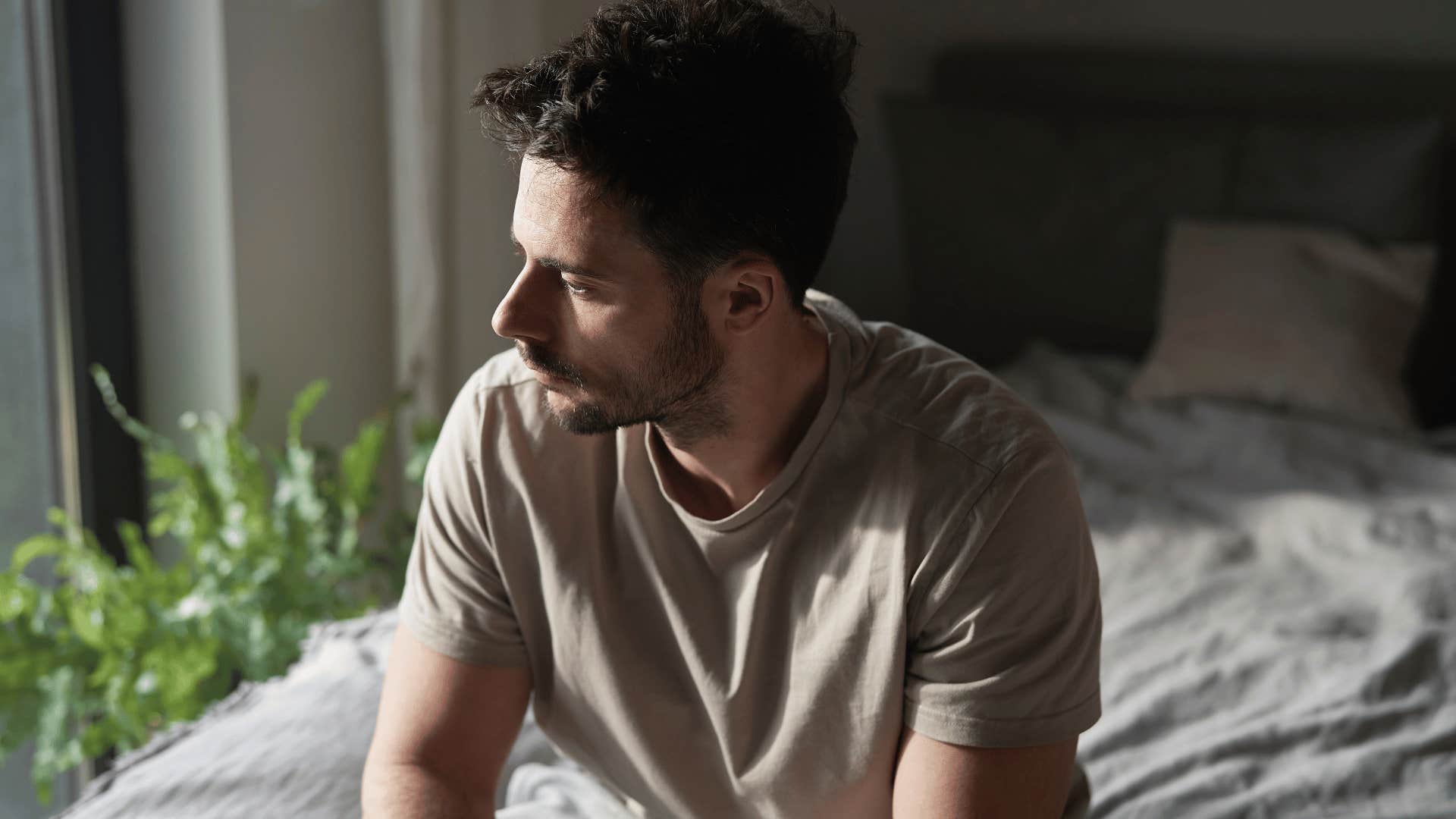 anxious man sitting on bed