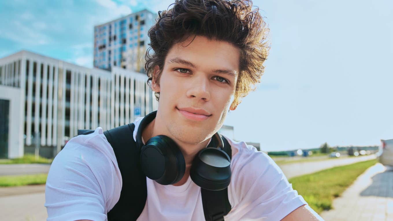 Selfie portrait of young man with curly hair