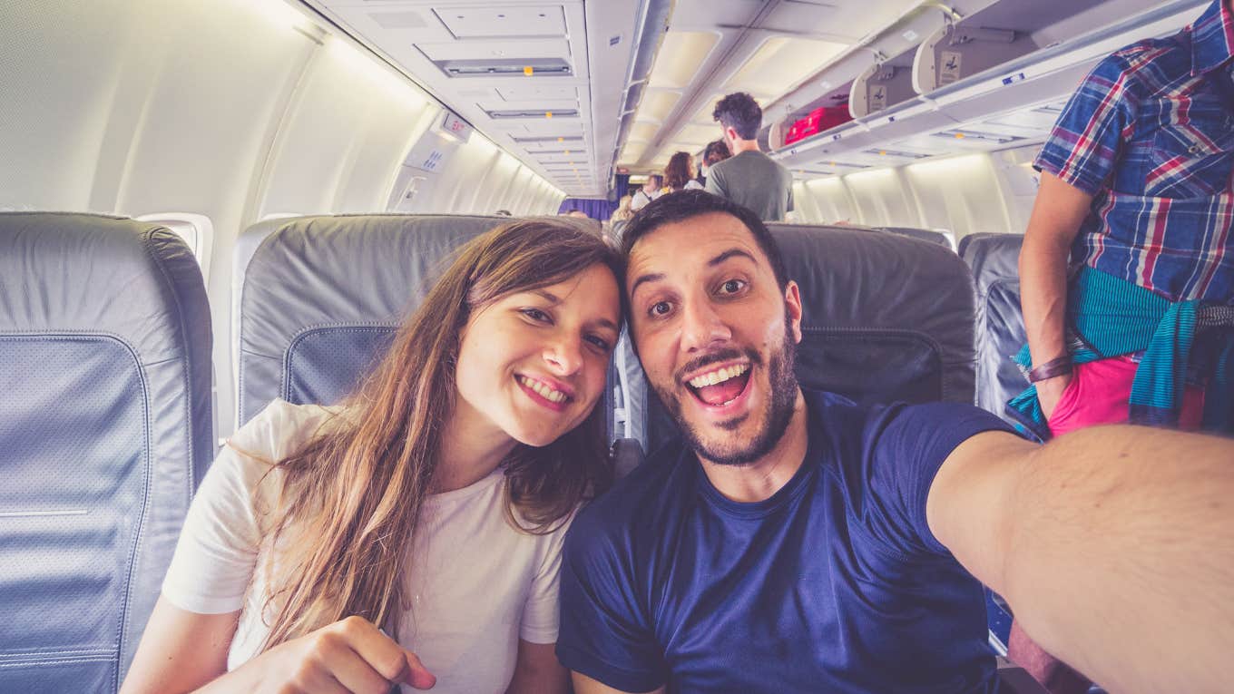 wife seated in middle seat and husband seated in aisle seat on a plane