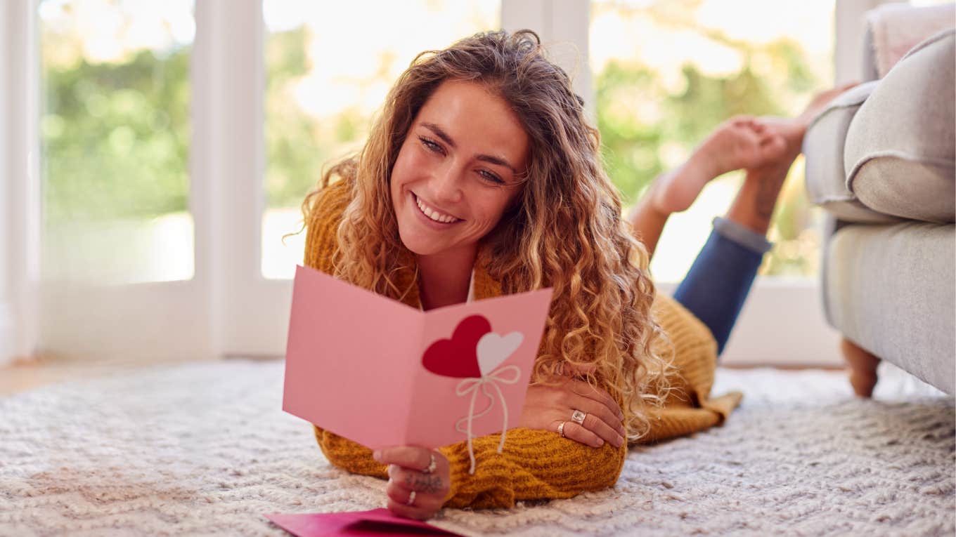 Woman reading Valentine's Day card from her dad