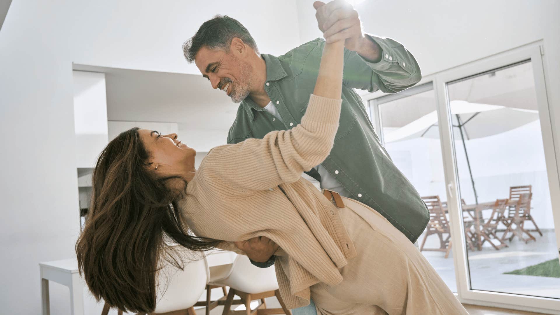 man dancing with woman in home