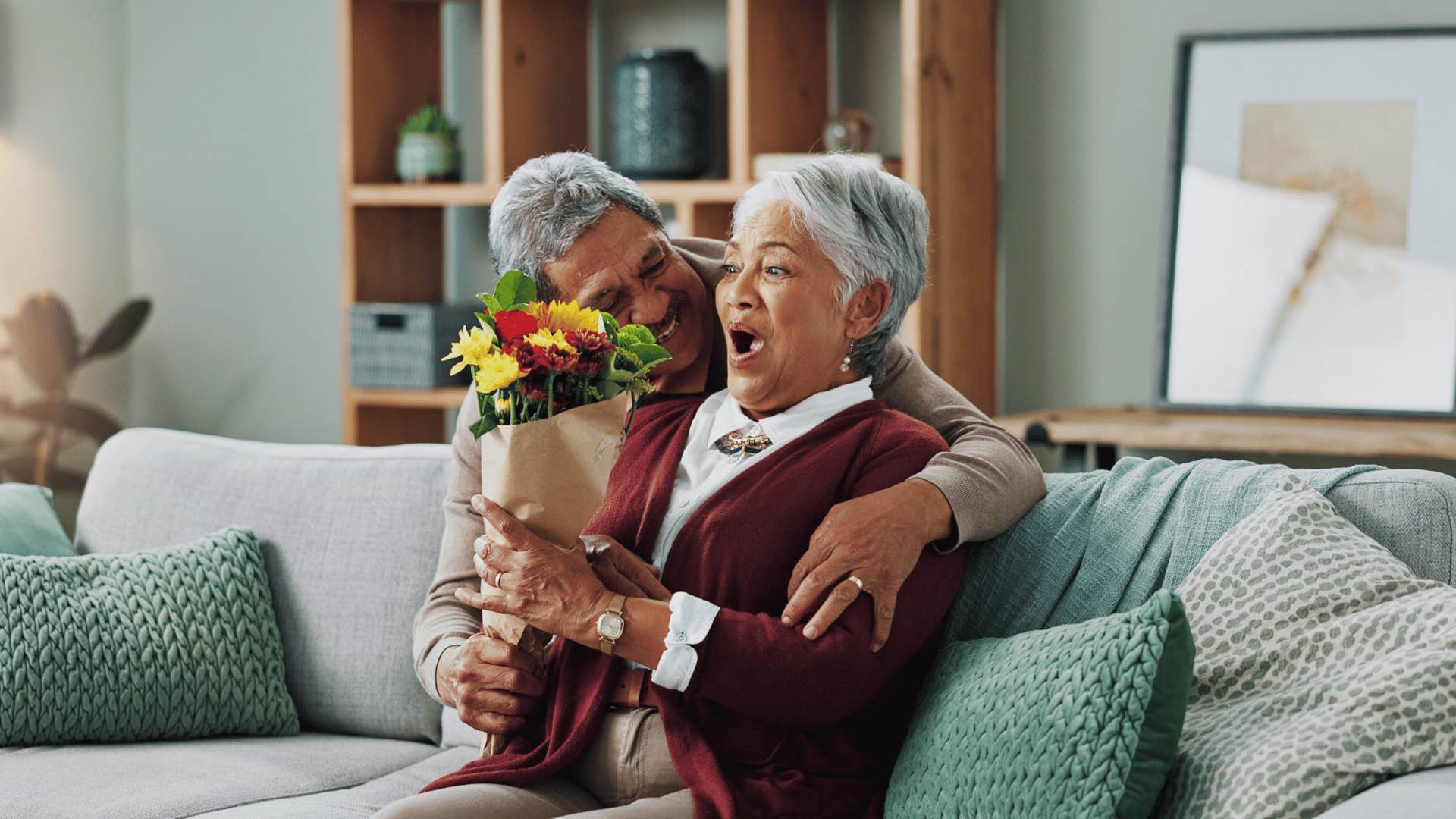 man surprising wife with flowers