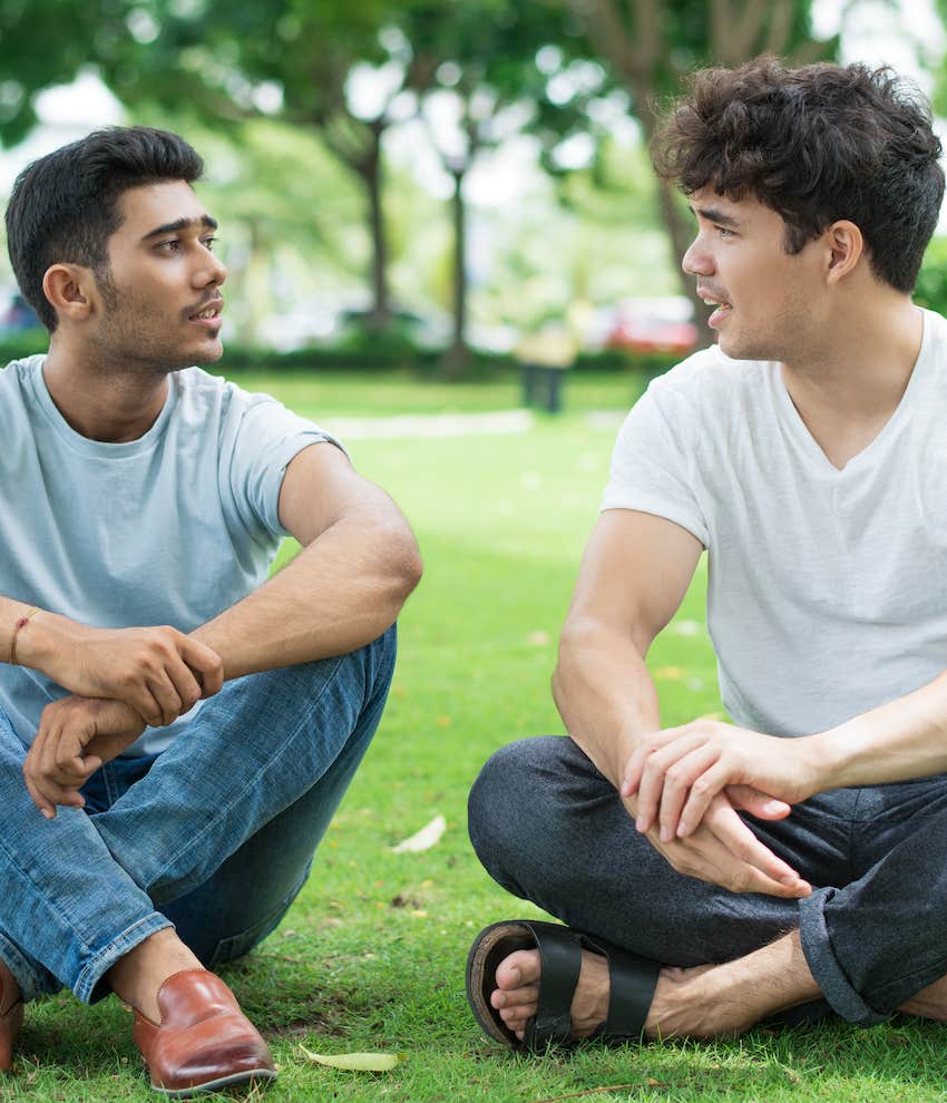 Two men sit in park about chat about loss of their first love