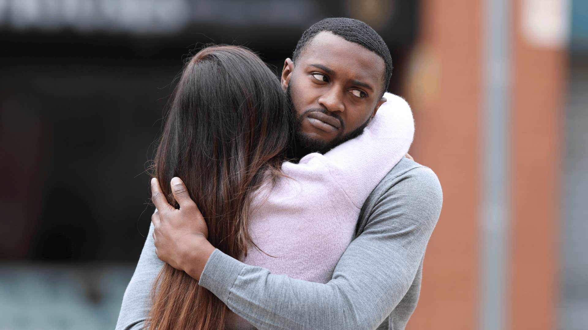 man not wanting to commit while hugging wife