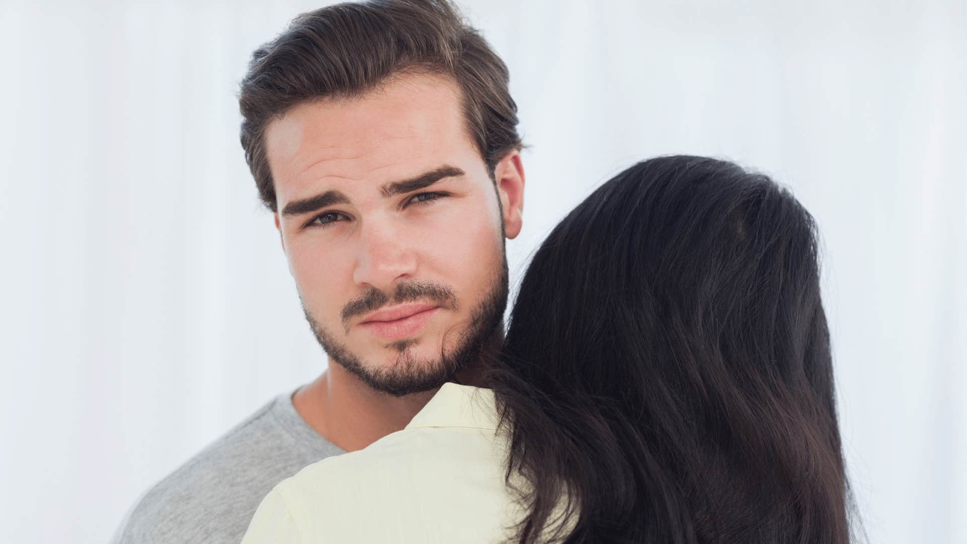 serious man holding his wife