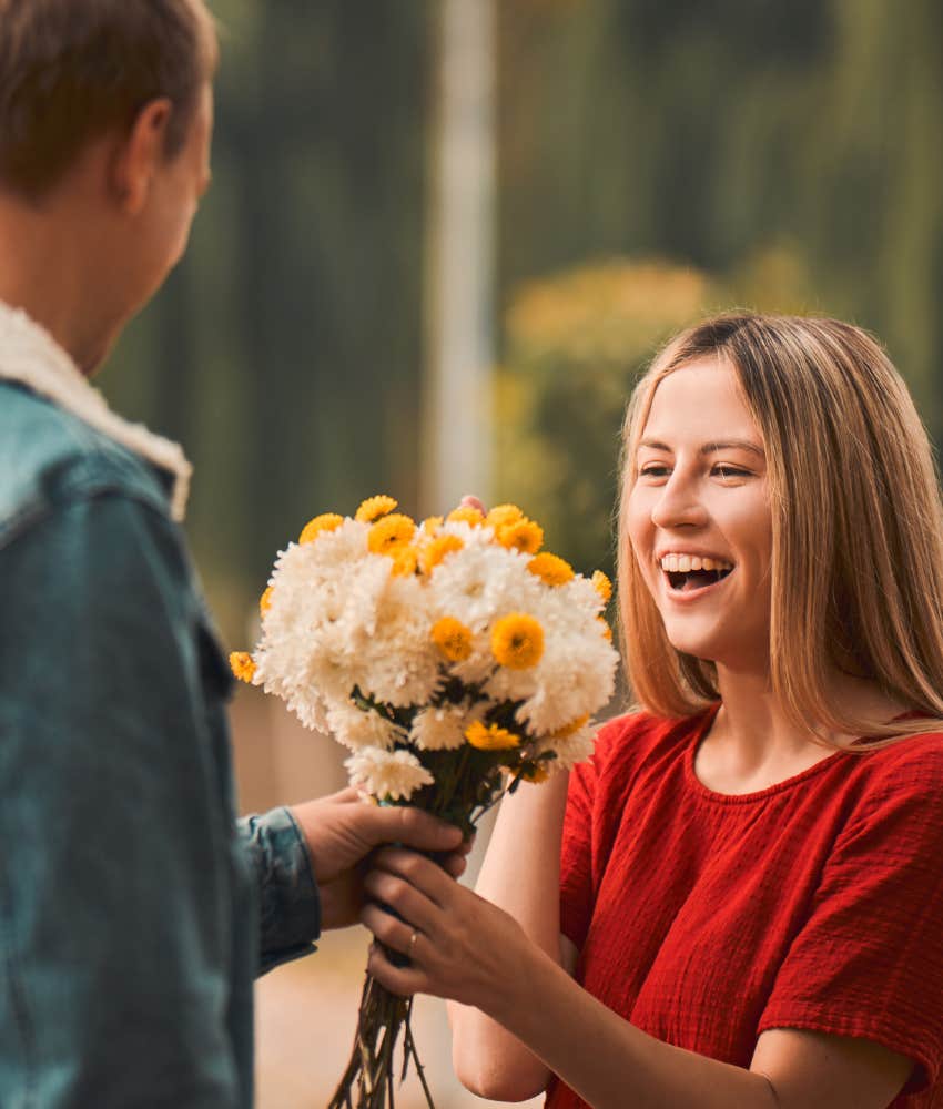 Man bringing flowers to woman, making first move per relationship rules