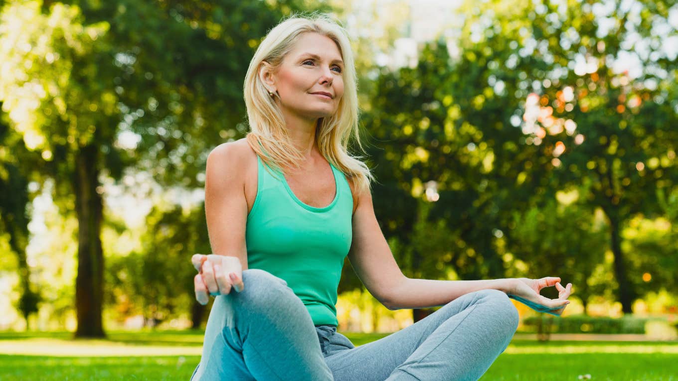 Woman meditating in park