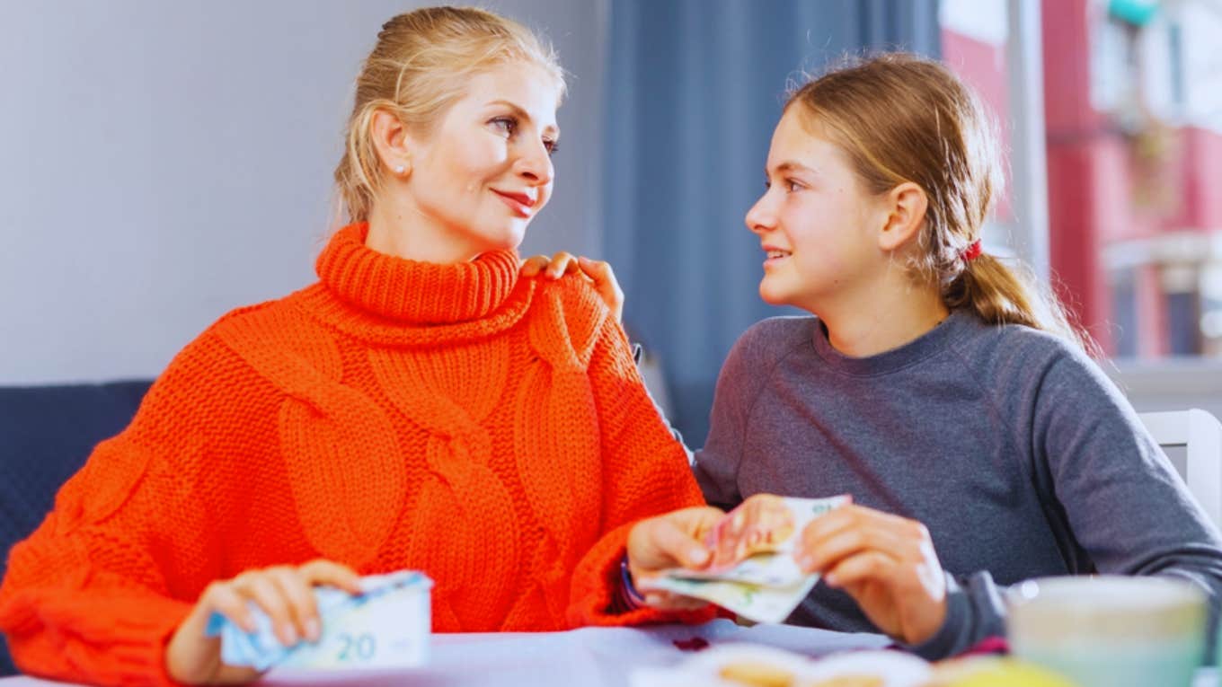 mom giving teen daughter money