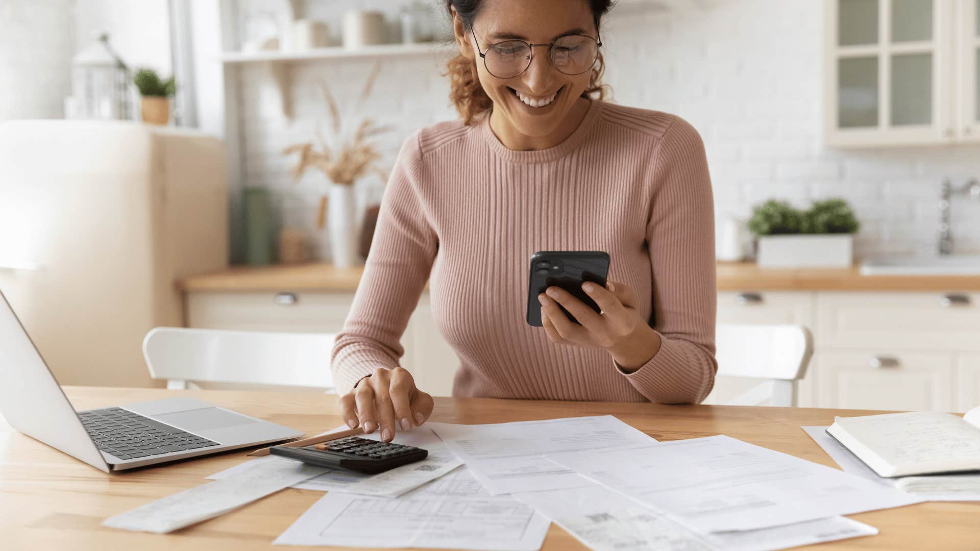 happy woman looking at bills