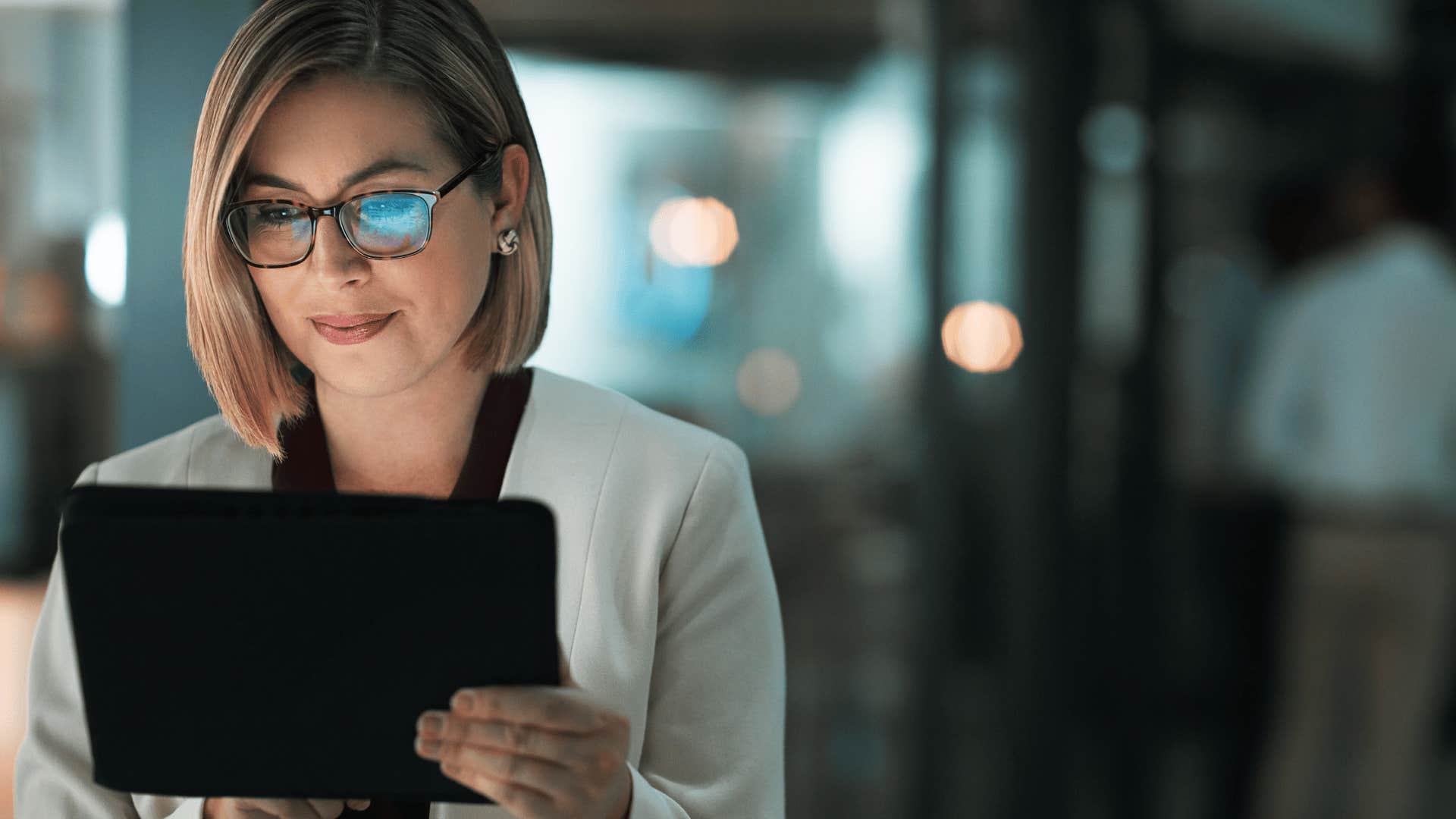 woman working on tablet at night