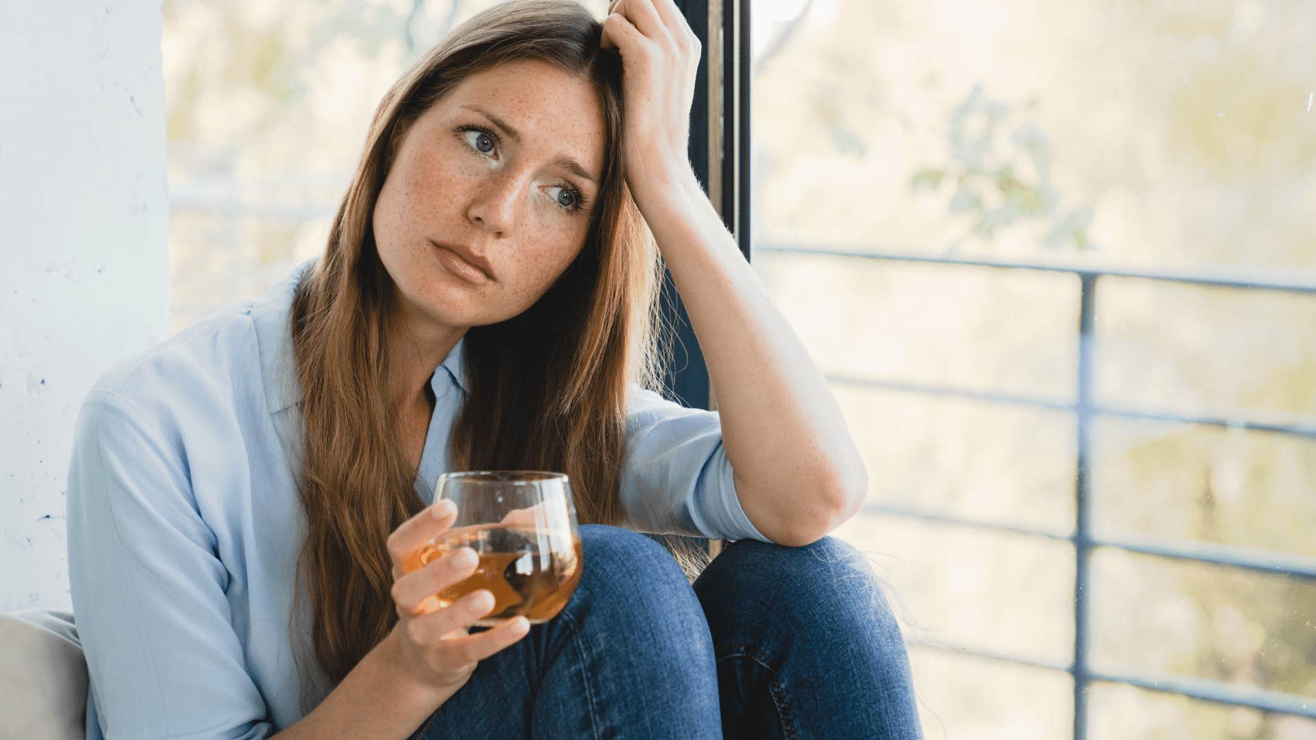 upset woman with drink in her hand