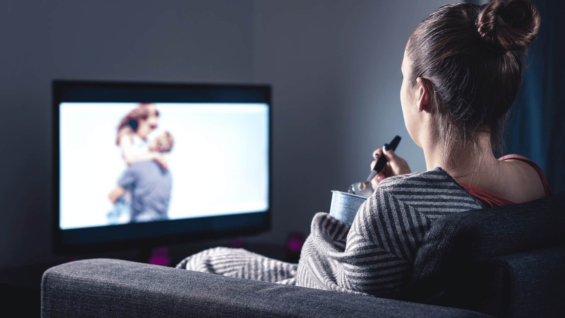 woman eating ice cream and watching movie