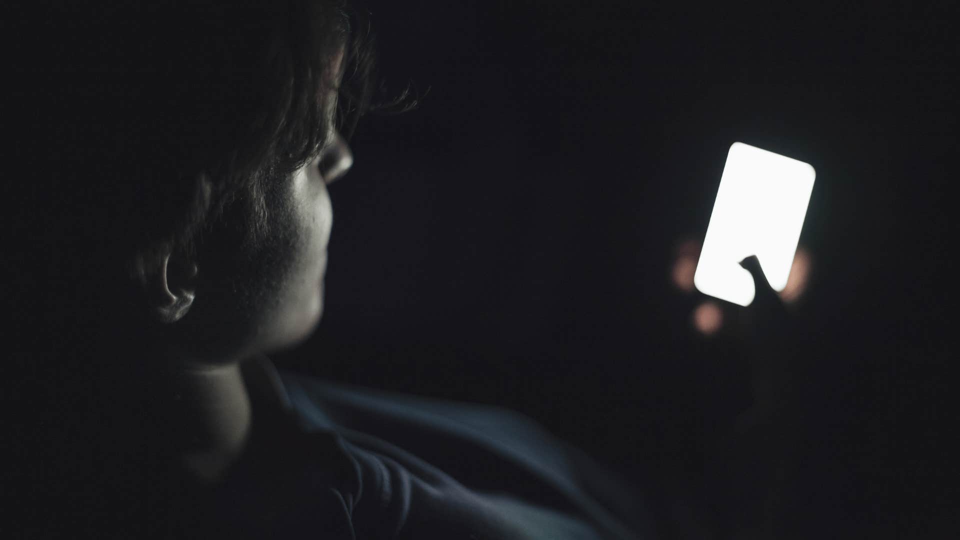 man on phone in dark