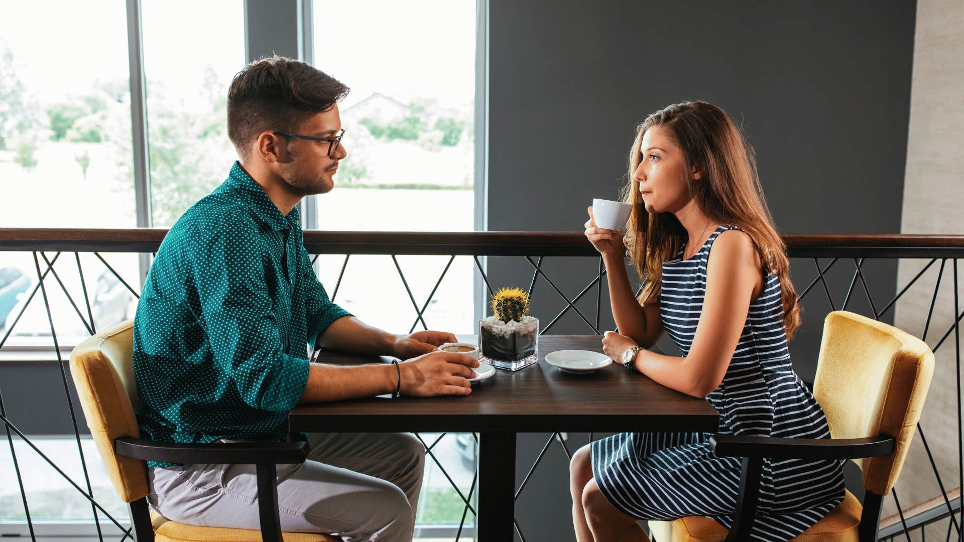 couple having tense conversation at restaurant