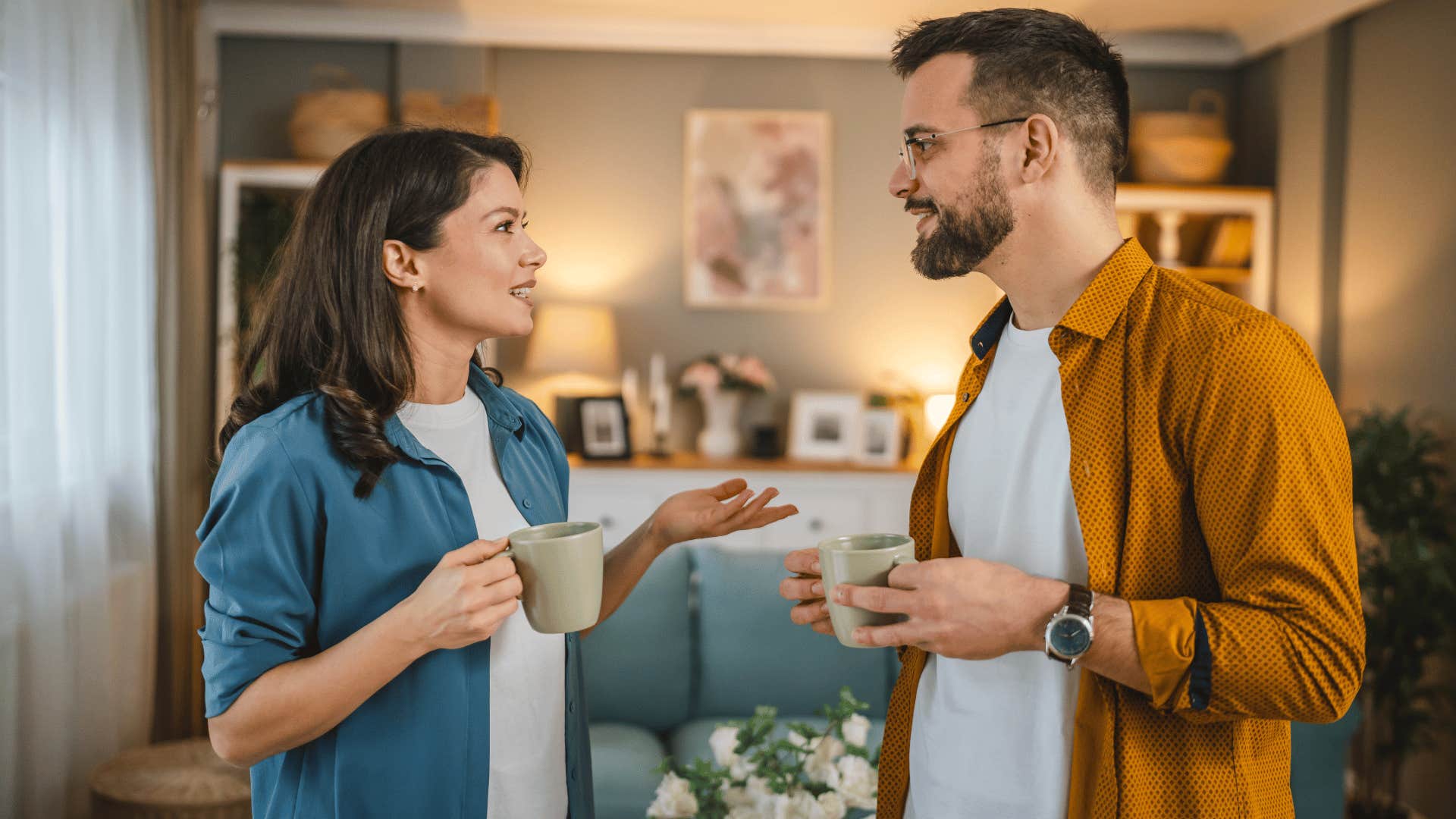 man and woman talking with open body language while drinking coffee