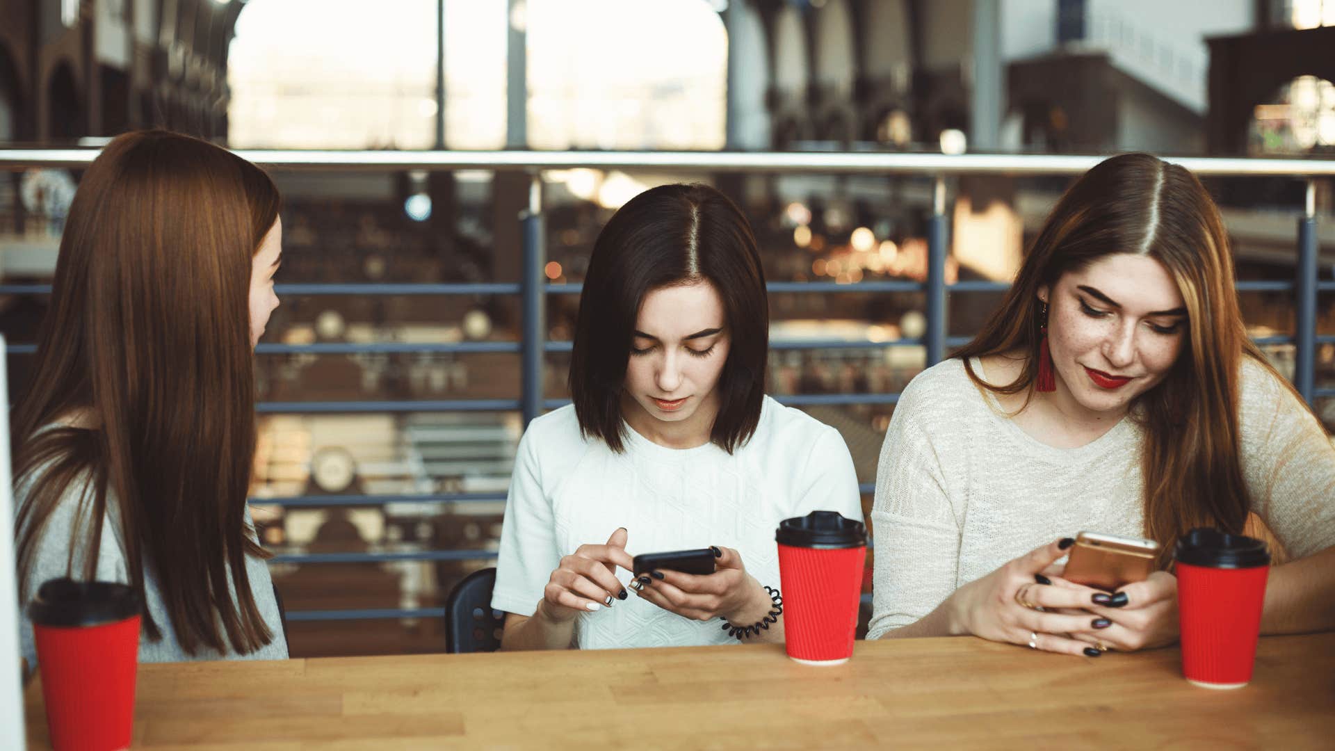 Woman trying to talk to their friends friends who use smart phones and do not listen to her