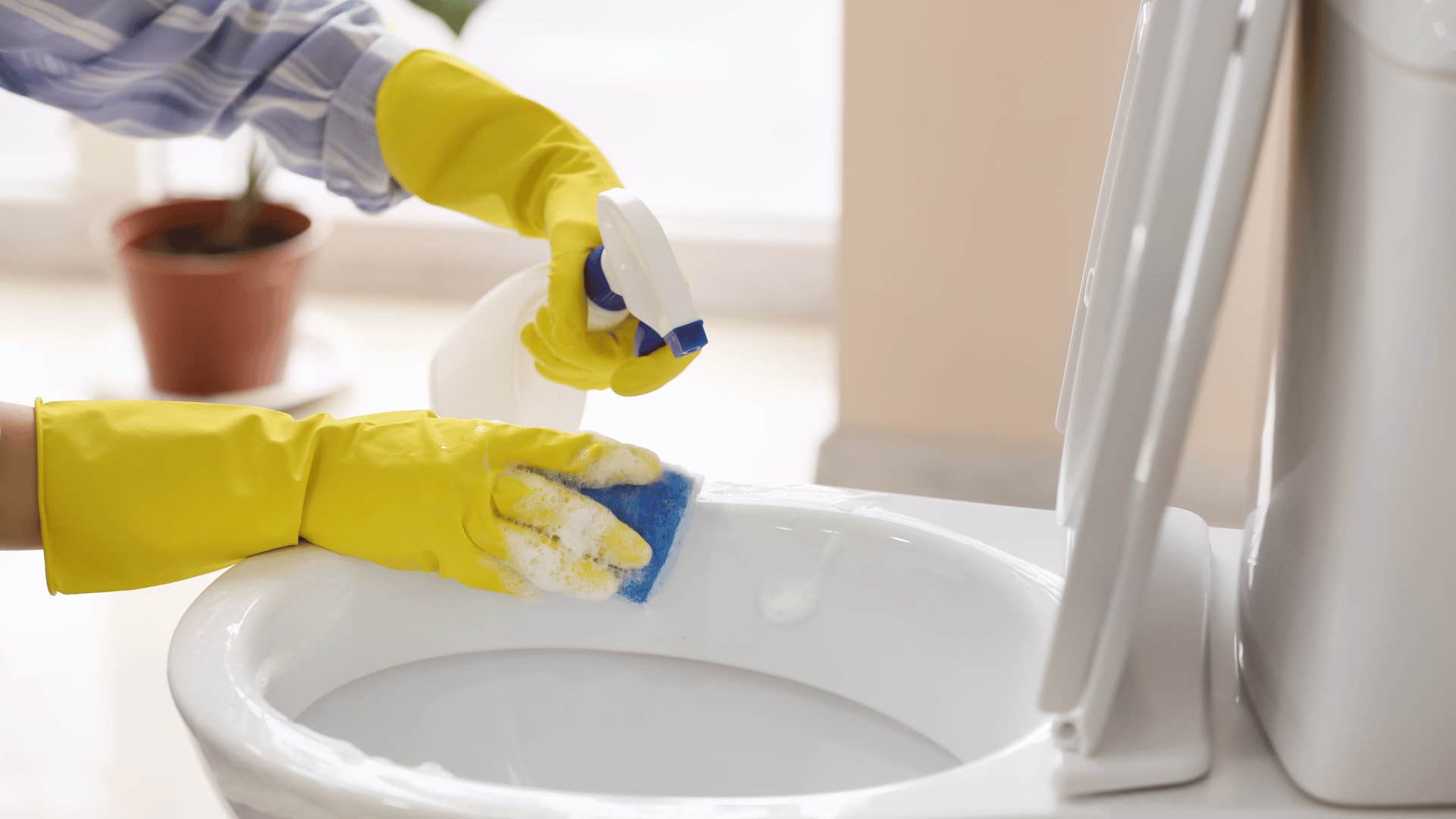 woman cleaning after narcissist left a mess in the bathroom