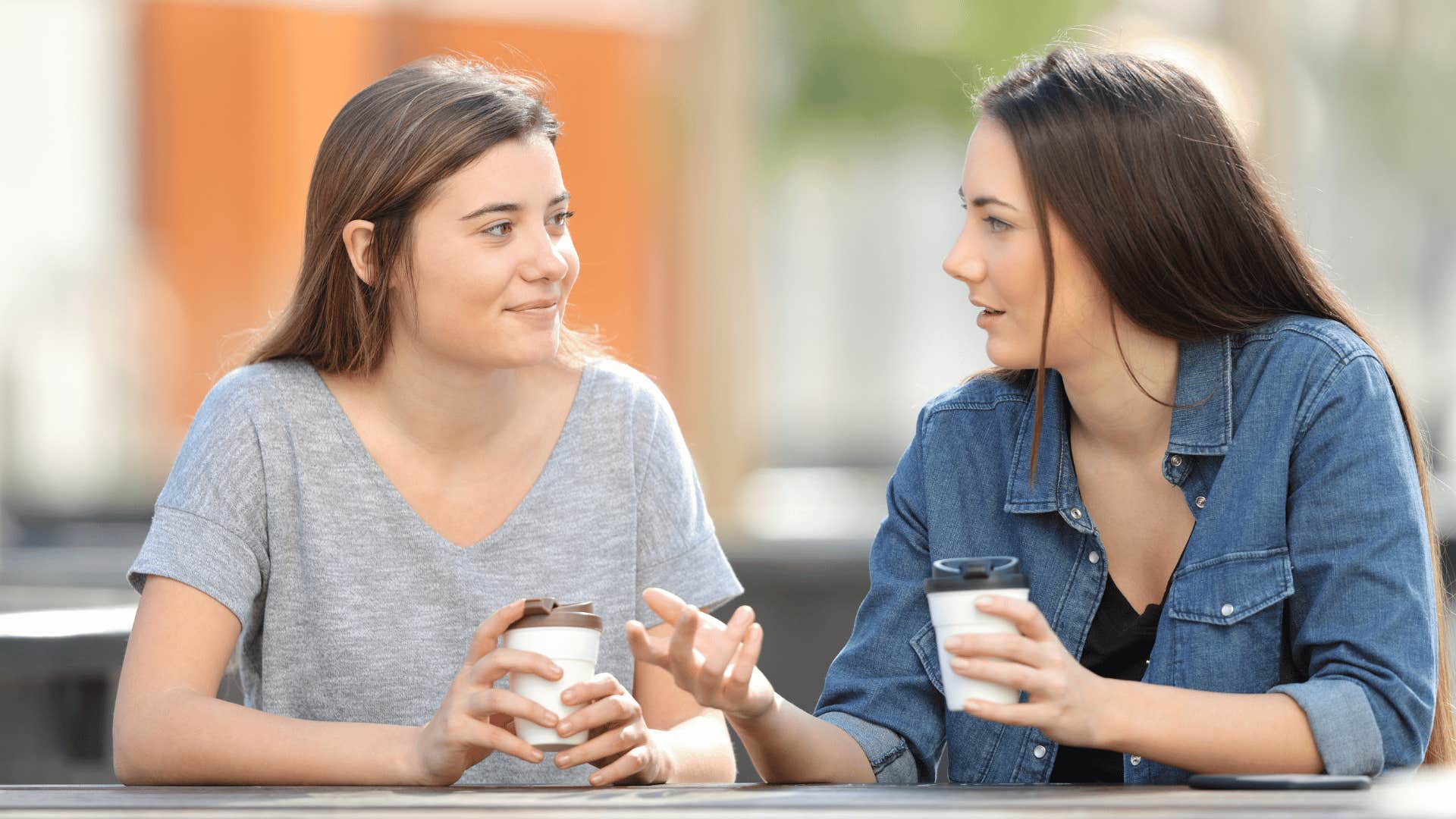 two women chatting while drinking coffee