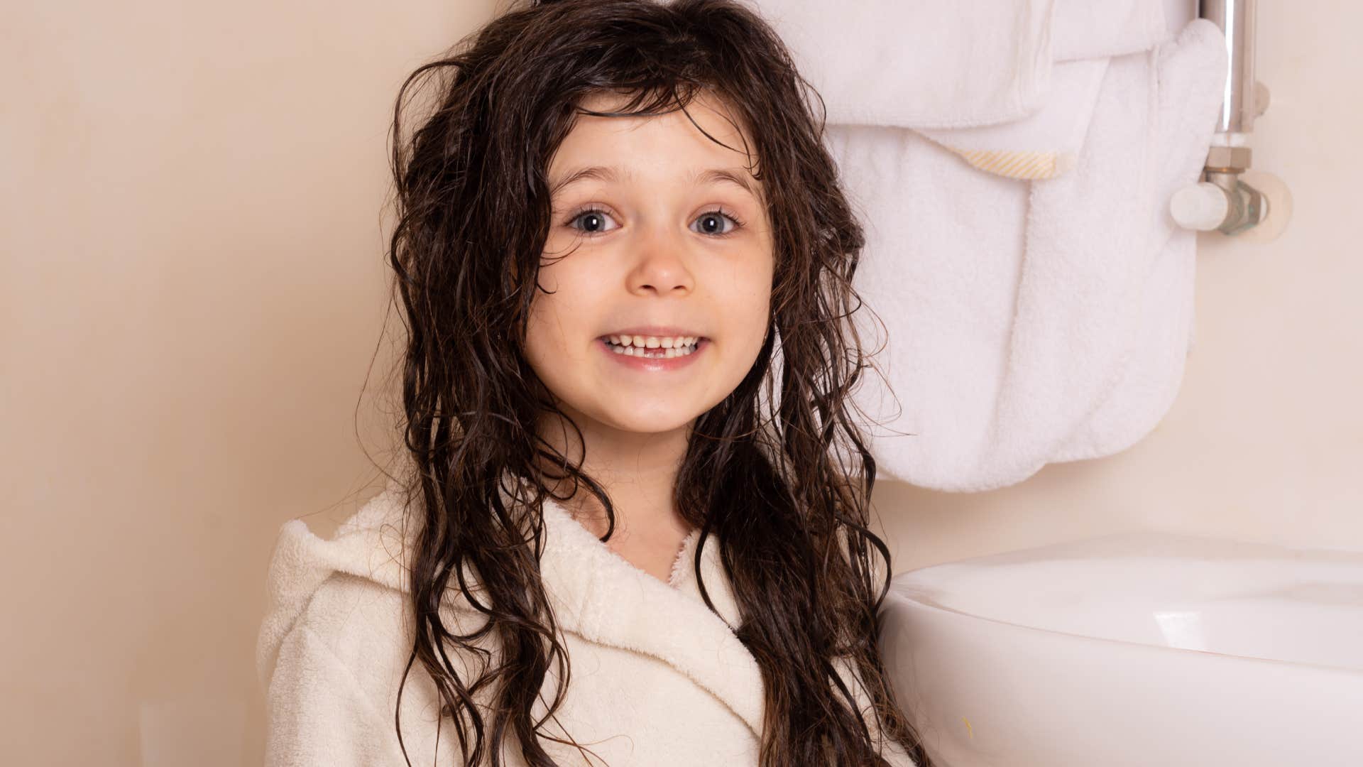 girl wearing a bathrobe with wet hair after bath or shower