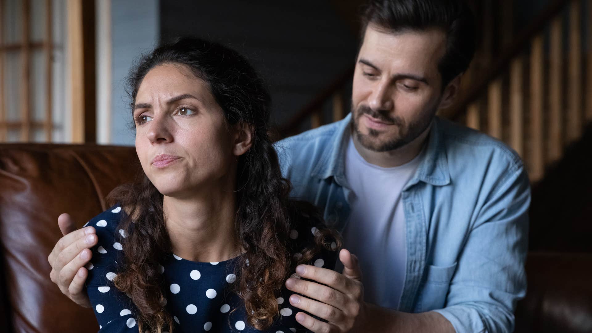 Man comforting his upset wife.