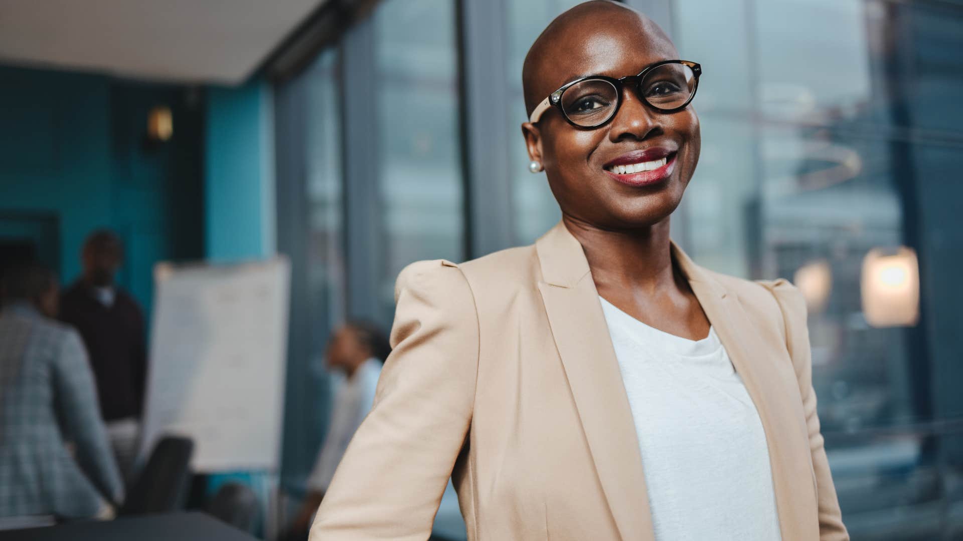 Professional woman smiling in an office.