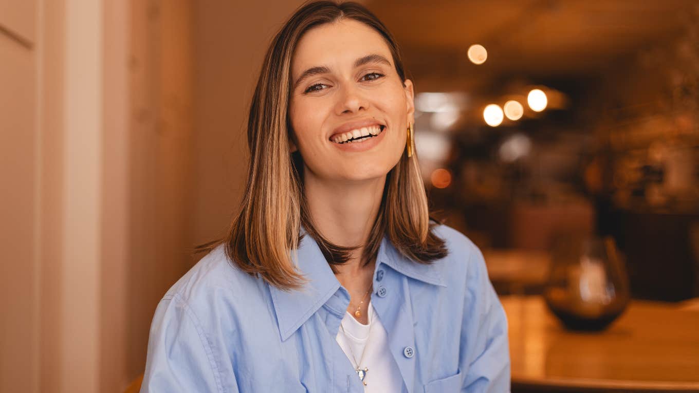 Happy woman smiling in a coffee shop. 