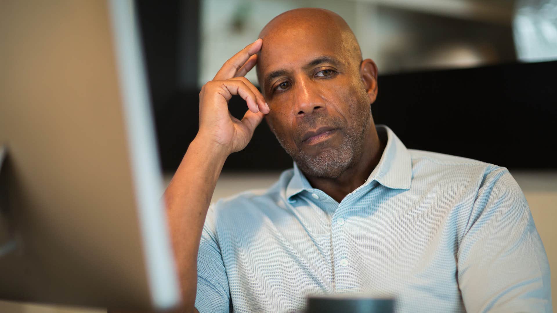 Concerned man sitting at his computer