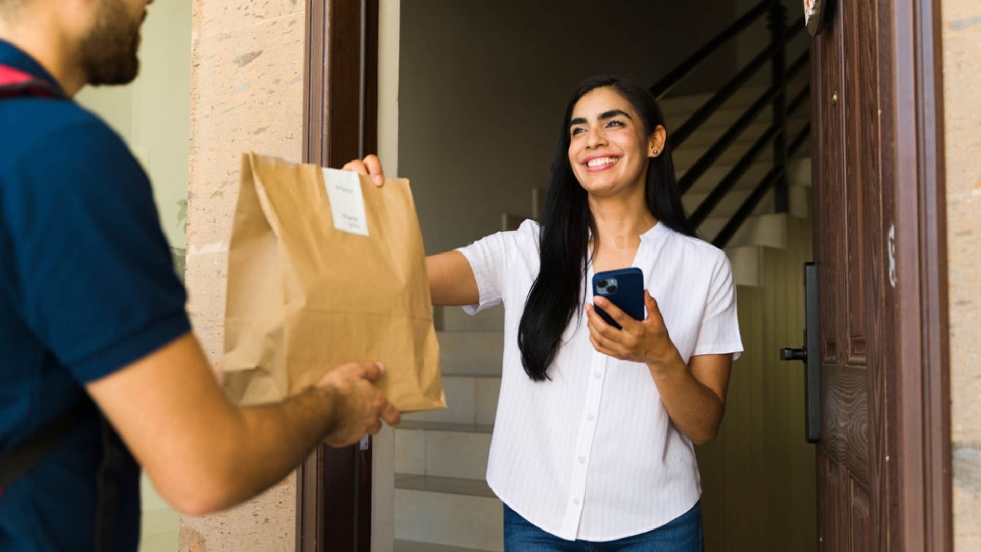 millennial woman ordering food on food delivery service app