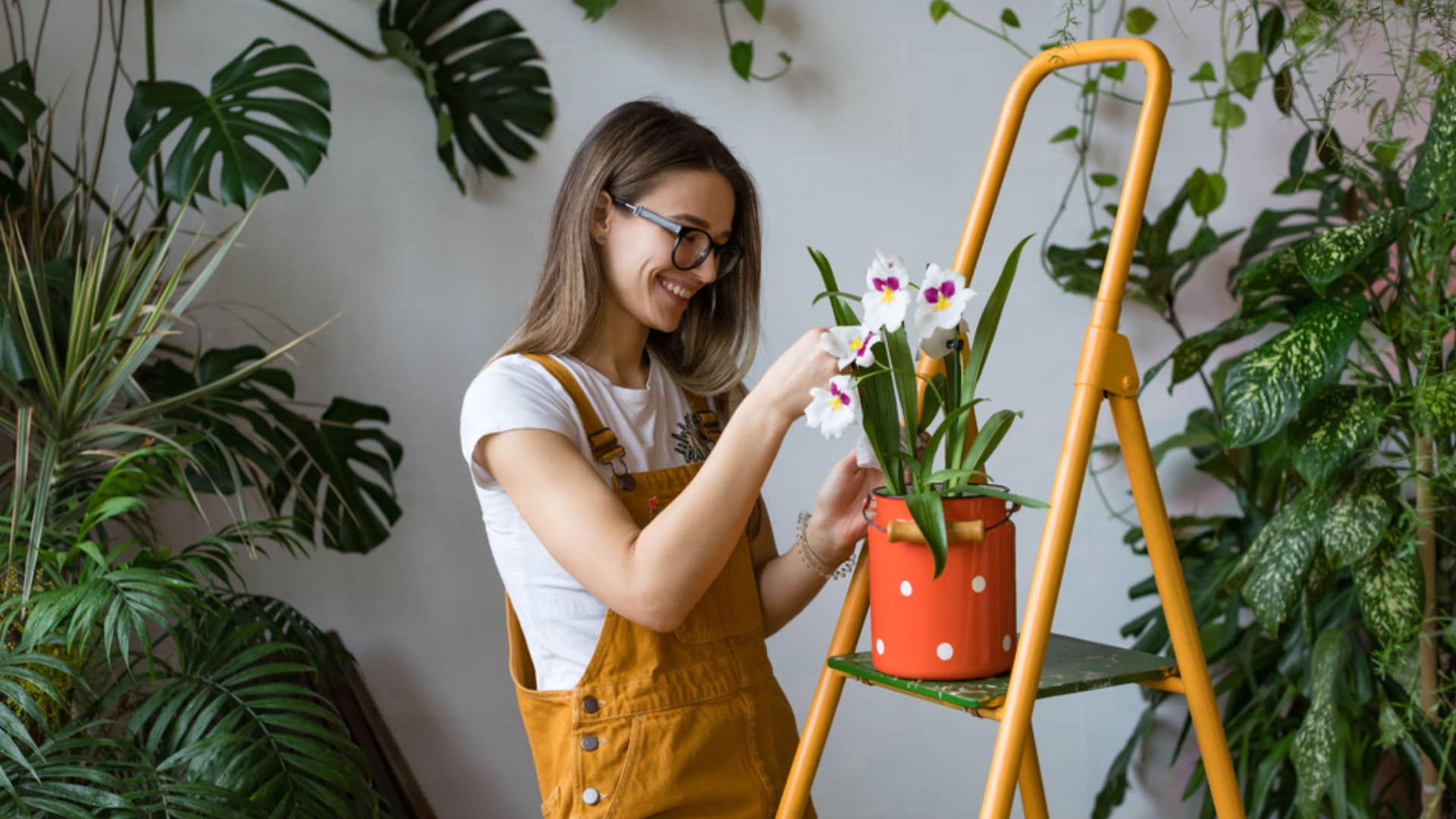 millennial women watering plants 