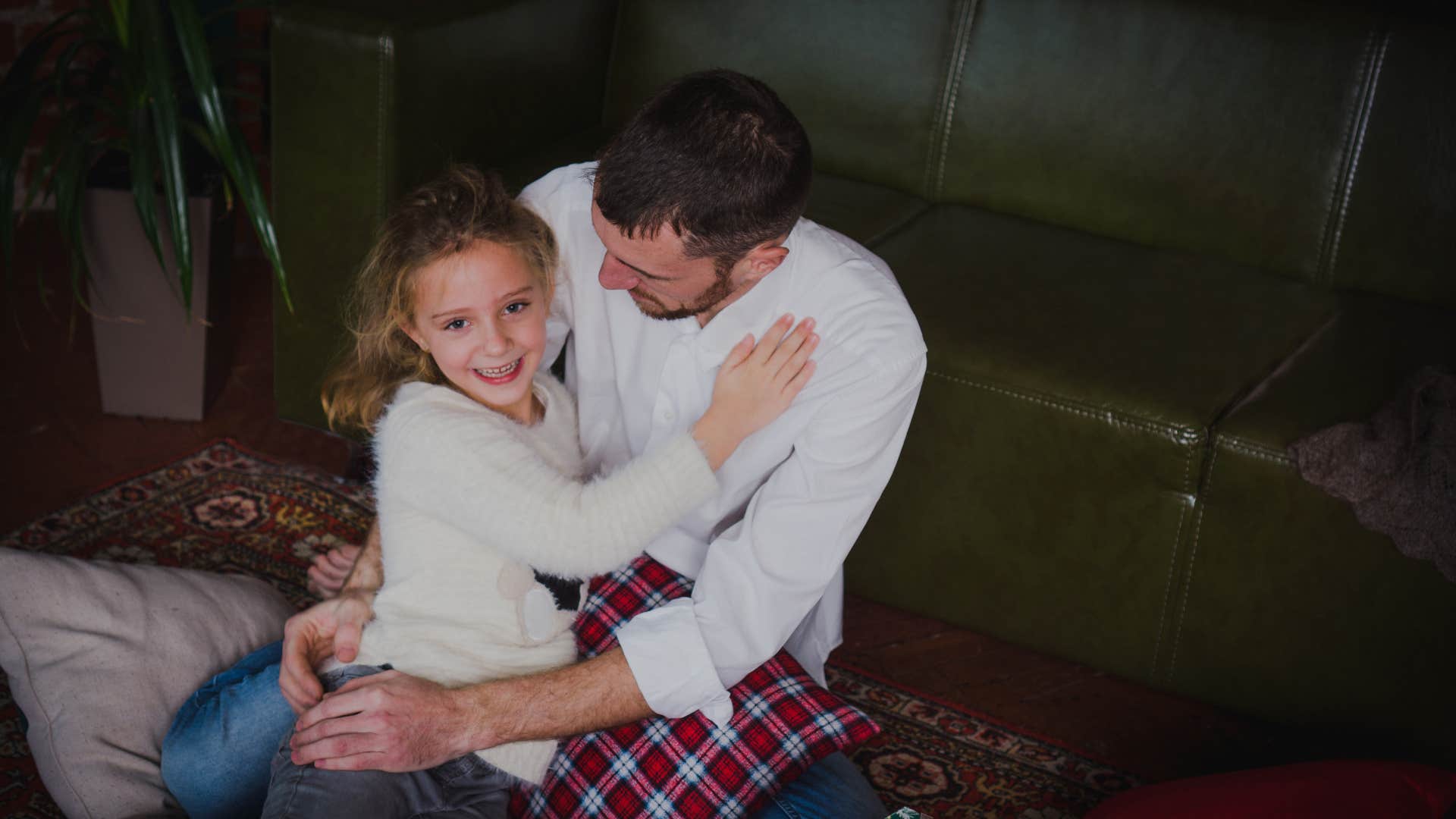 dad hugs his little daughter very tight