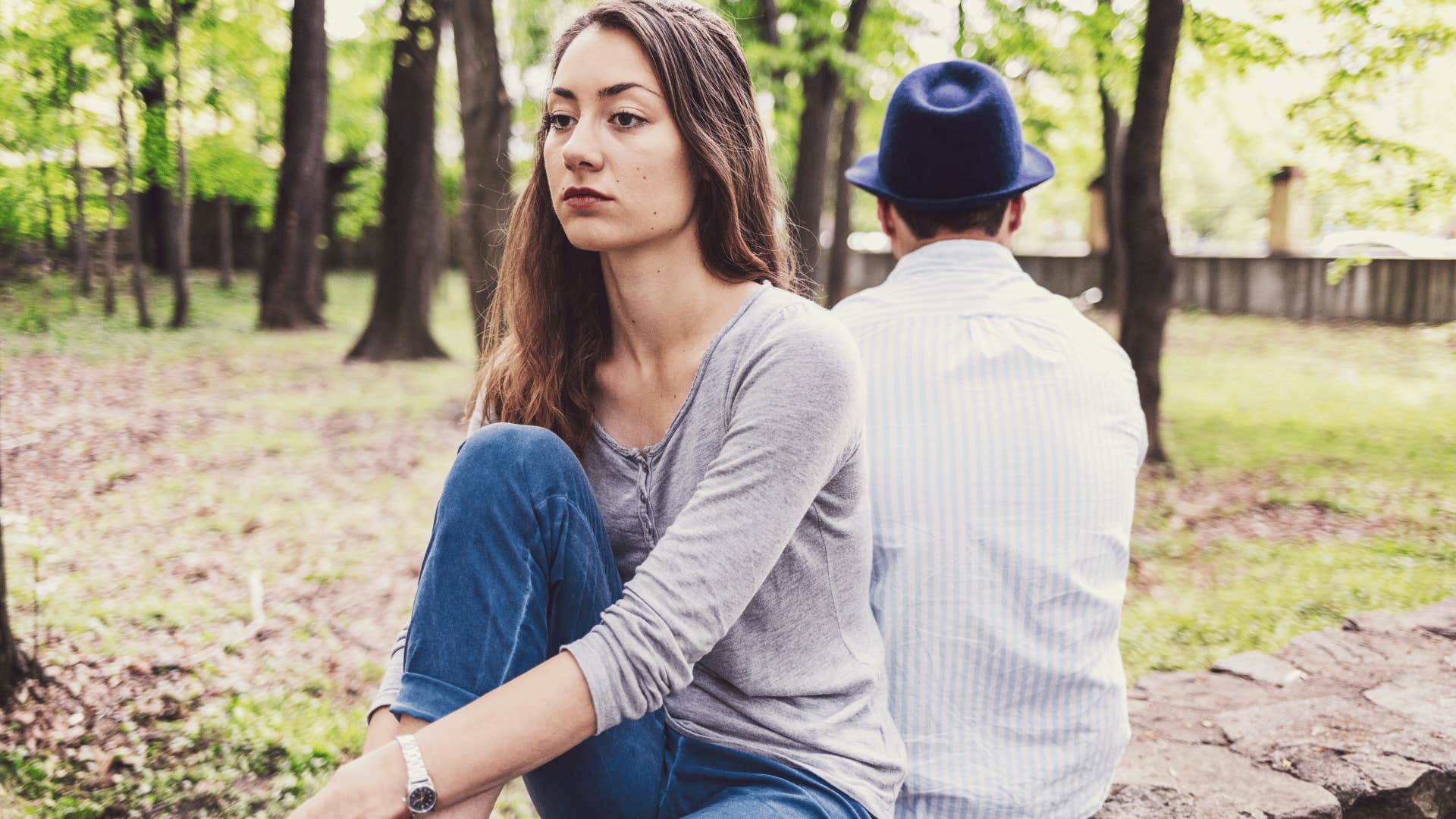 woman sitting with her back to an emotionally limited man-child