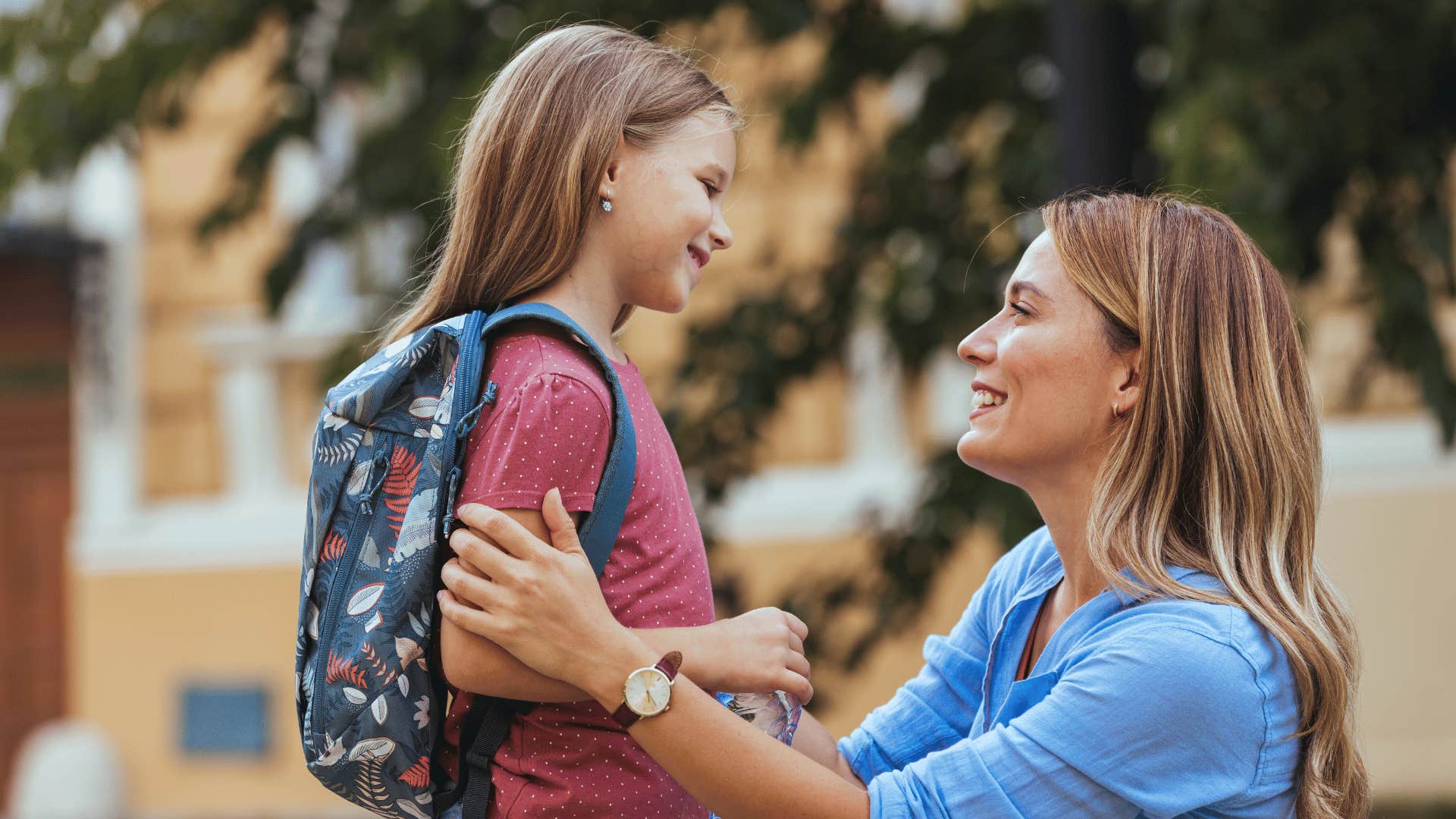 mother talking to child with backpack