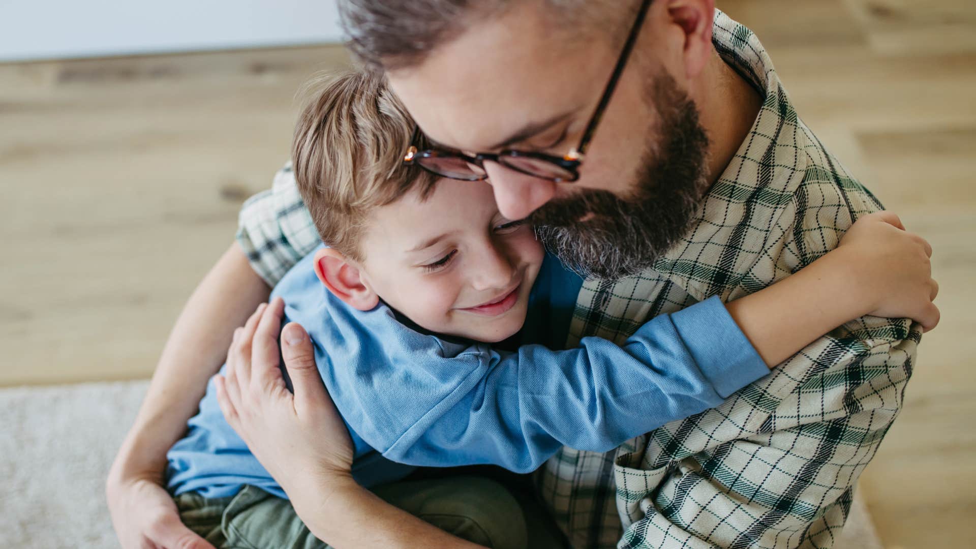 dad cuddling with son