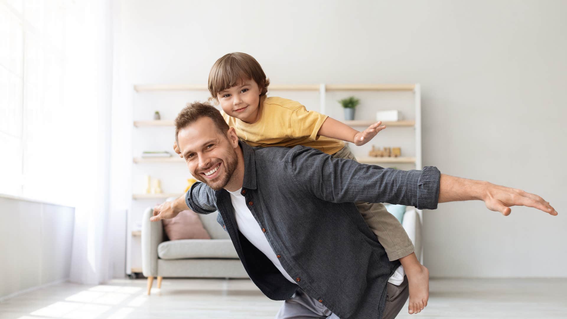 little boy riding on dad's back